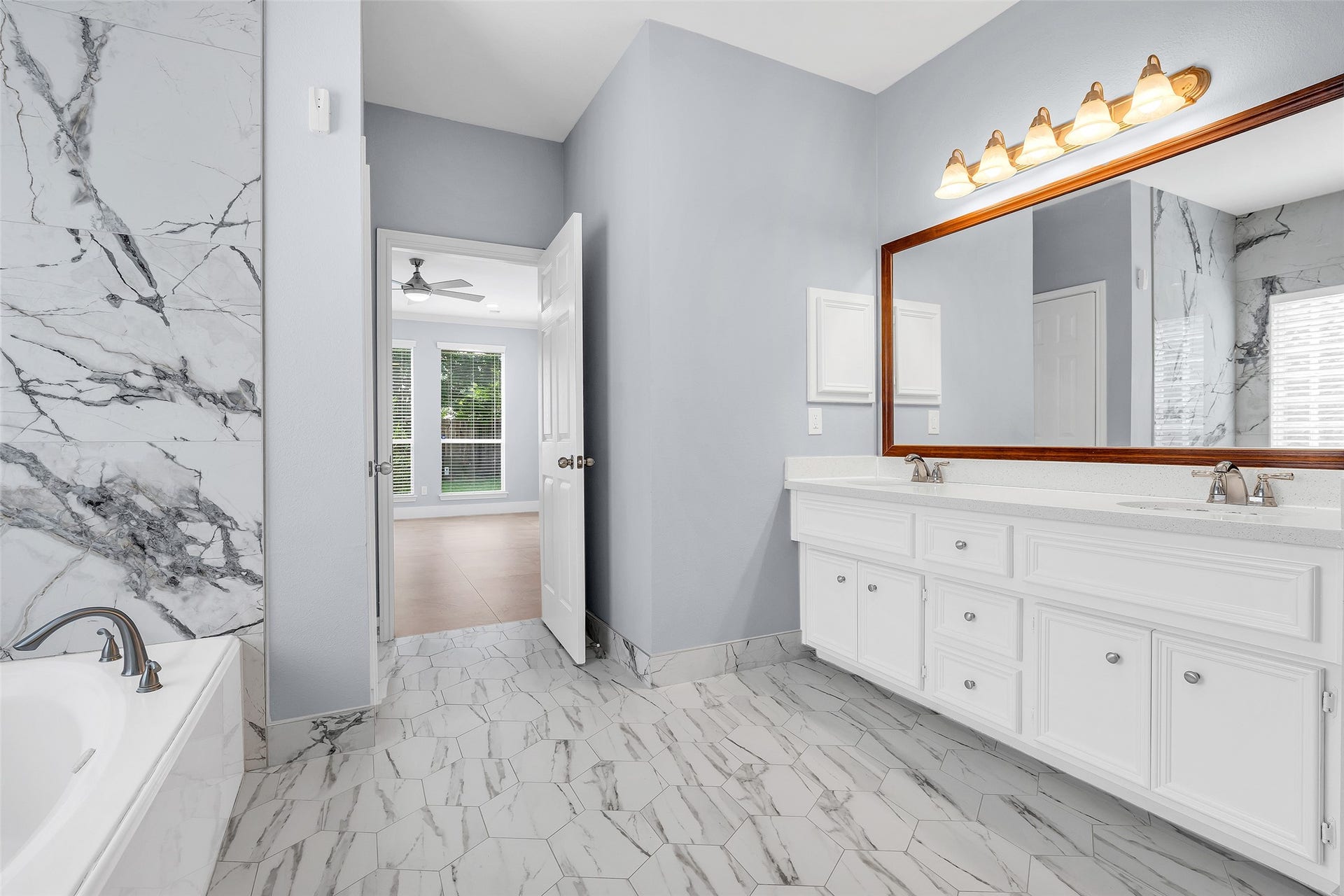 10626 Cortland Ridge Lane, Cypress, TX 77433 Experience luxury in the primary bathroom adorned with elegant Italian tile and a sleek glass-encased shower.