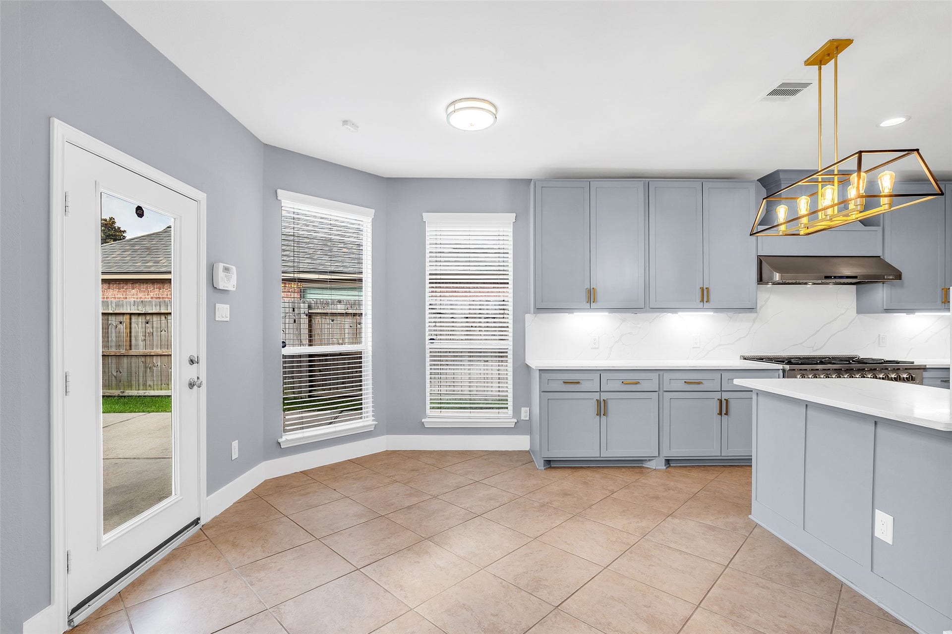 10626 Cortland Ridge Lane, Cypress, TX 77433 Bright and inviting, the breakfast nook offers a seamless blend of style and function with its modern cabinetry, sleek countertops, and abundant natural light.