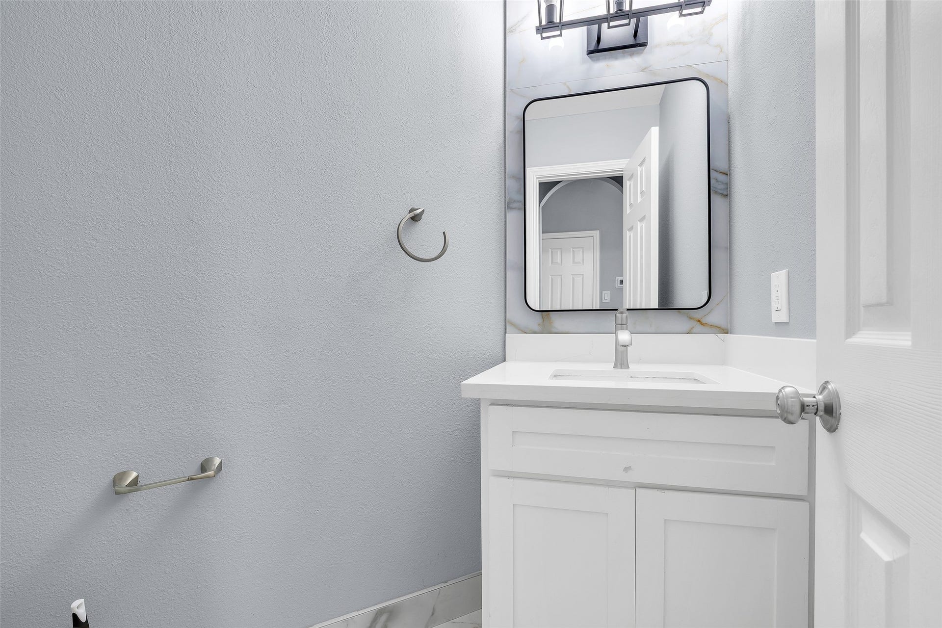 10626 Cortland Ridge Lane, Cypress, TX 77433 Chic and modern powder room with sleek fixtures and a stylish vanity, perfect for guests.