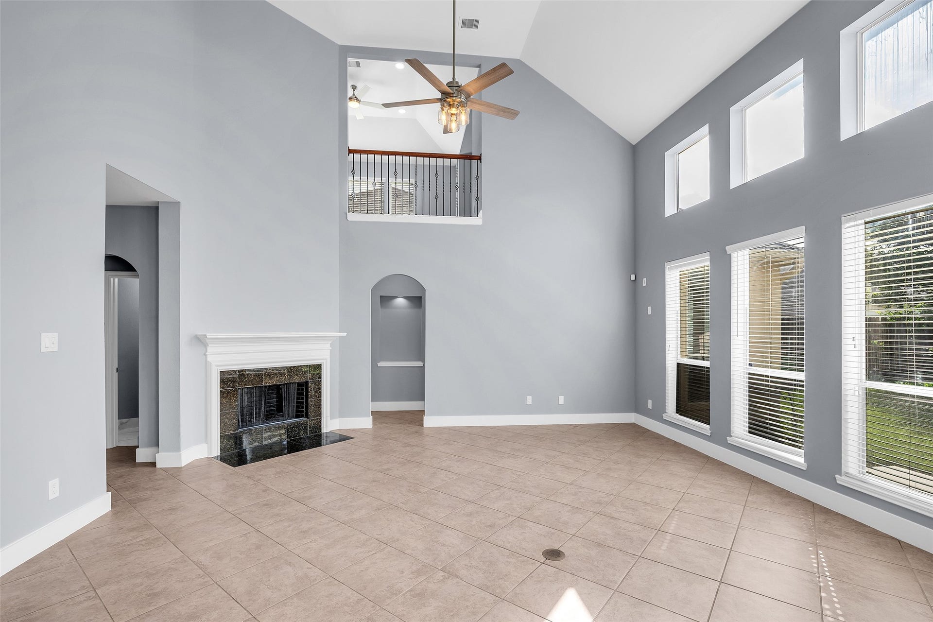 10626 Cortland Ridge Lane, Cypress, TX 77433 Experience elegant living in this spacious, light-filled room featuring soaring ceilings, expansive windows, a cozy fireplace, and a stylish balcony overlook from the game room!