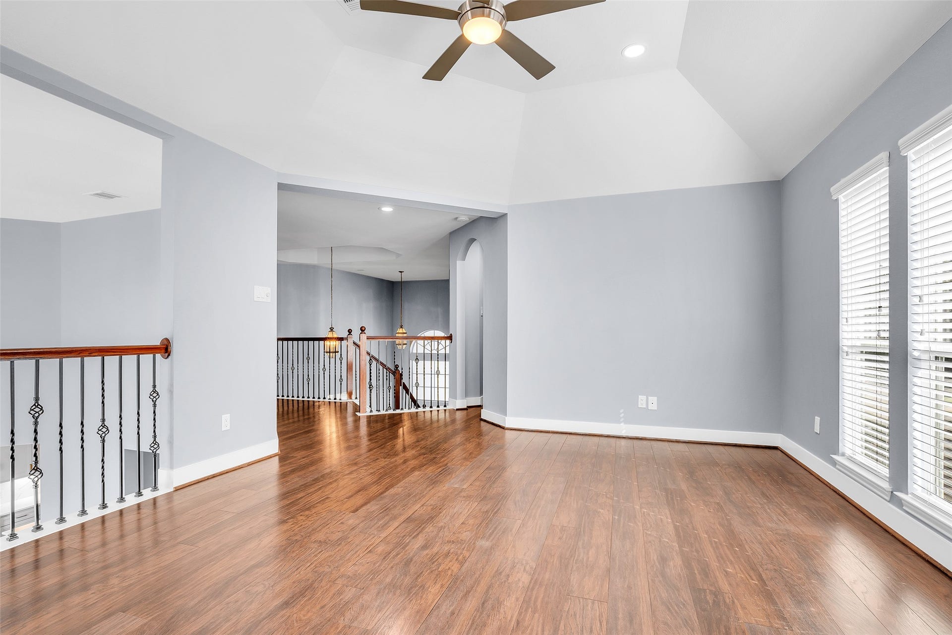 10626 Cortland Ridge Lane, Cypress, TX 77433 Your spacious game room, featuring sleek wood floors, abundant natural light, and a modern ceiling fan, perfect for endless hours of fun and relaxation.