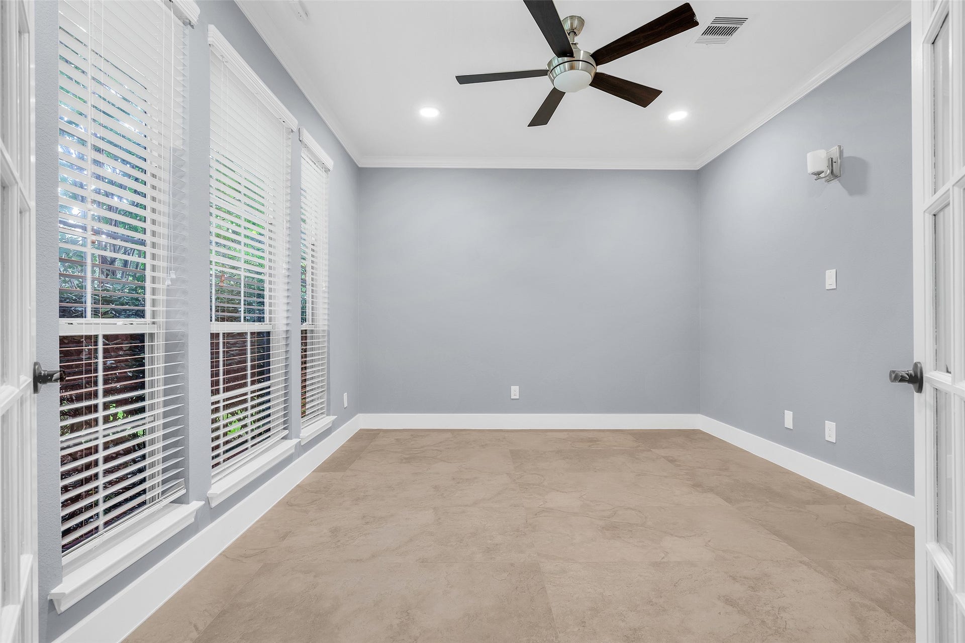 10626 Cortland Ridge Lane, Cypress, TX 77433 Bright and inviting, this study features large windows that fill the space with natural light, complemented by elegant French doors and modern finishes for a perfect work-from-home retreat.