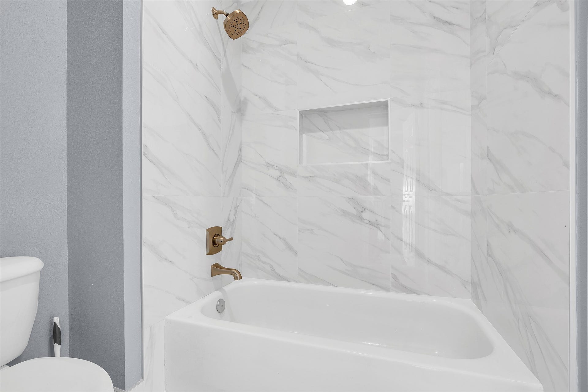 10626 Cortland Ridge Lane, Cypress, TX 77433 Experience elegance in this bathroom featuring stunning marble-look tiles, perfectly complementing the modern fixtures.