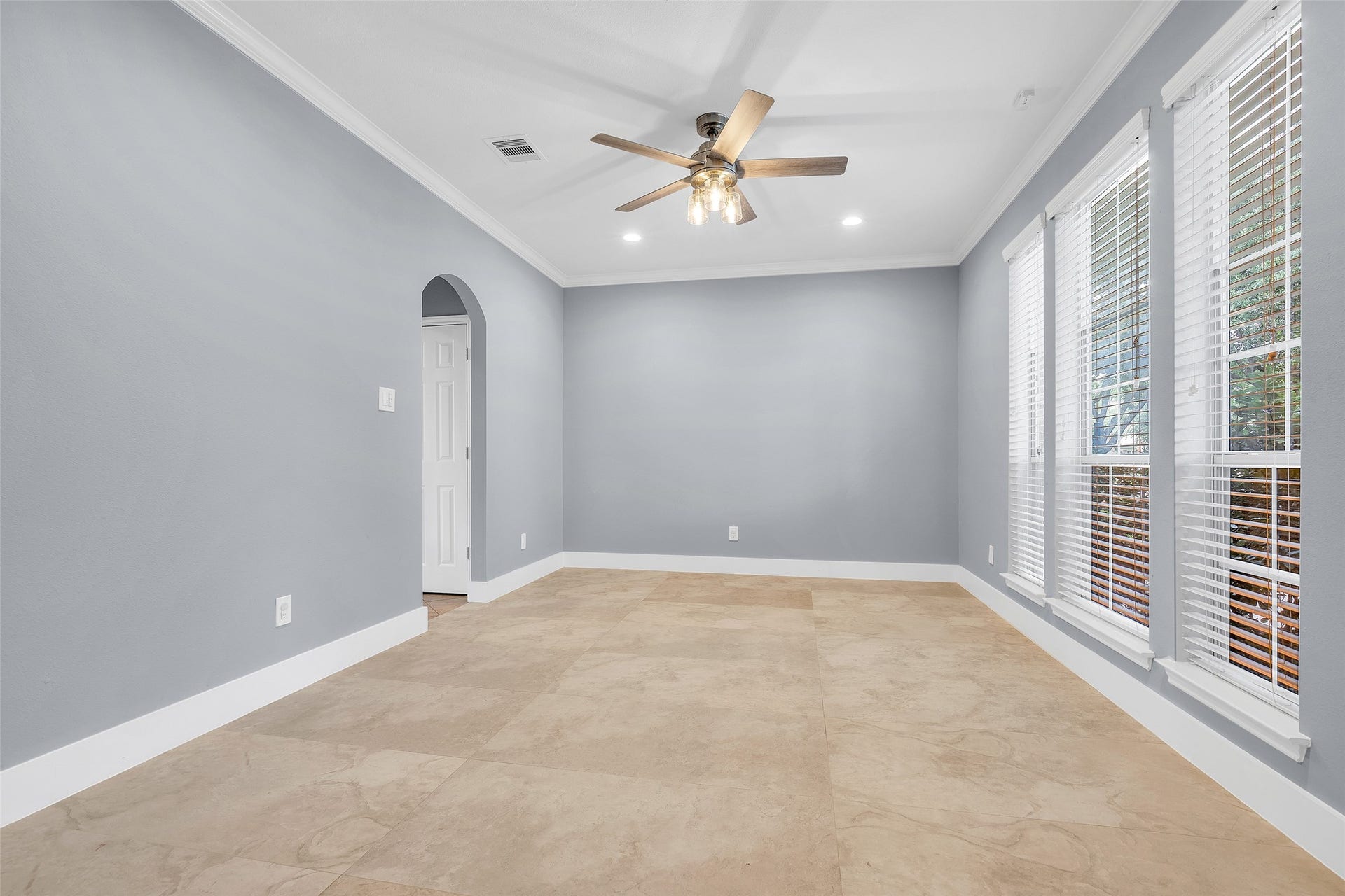 10626 Cortland Ridge Lane, Cypress, TX 77433 Experience elegant dining in this beautifully lit room featuring a modern ceiling fan, sleek tile flooring, and expansive windows that invite natural light and warmth.