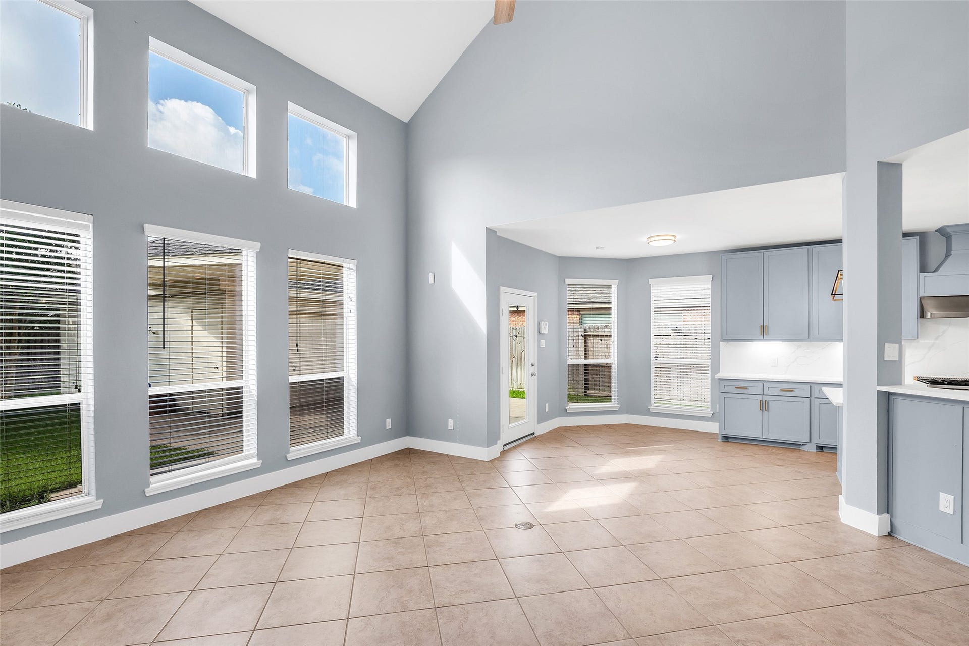 10626 Cortland Ridge Lane, Cypress, TX 77433 Spacious open-concept living area with high ceilings, abundant natural light from large windows, and a seamless flow into a modern kitchen with stylish cabinetry.