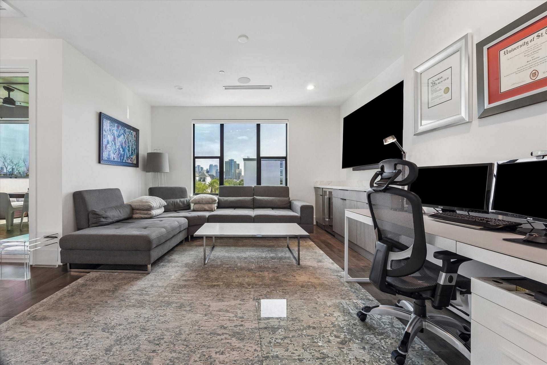2435 Sheridan Street, Houston, TX 77030 Step into your ultimate media havenfeaturing a sleek entertainment center, cozy sectional seating, and stunning sunset views.