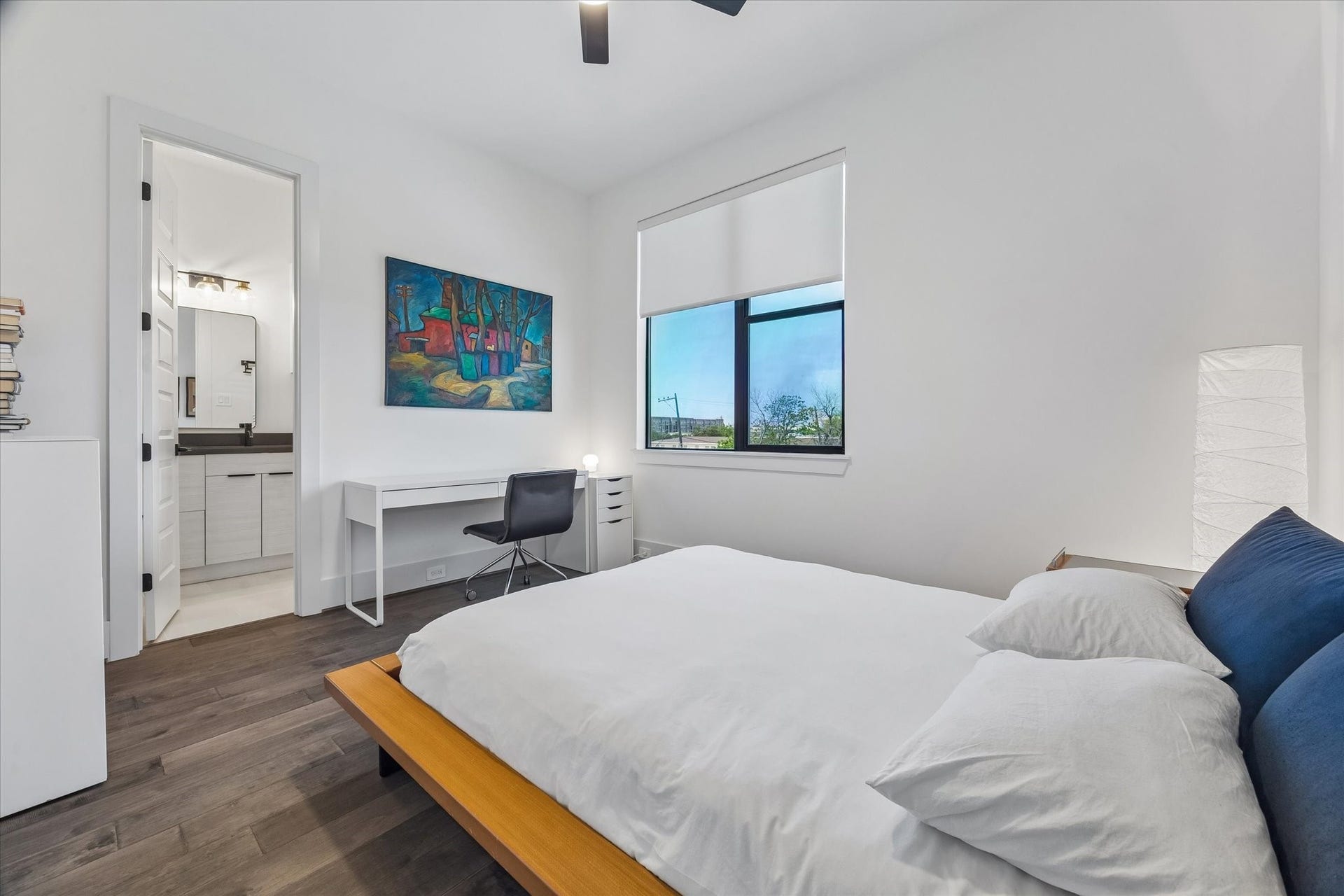 2435 Sheridan Street, Houston, TX 77030 This bedroom offers another serene retreat with sleek hardwood floors, ample natural light, and a stunning sunset view.