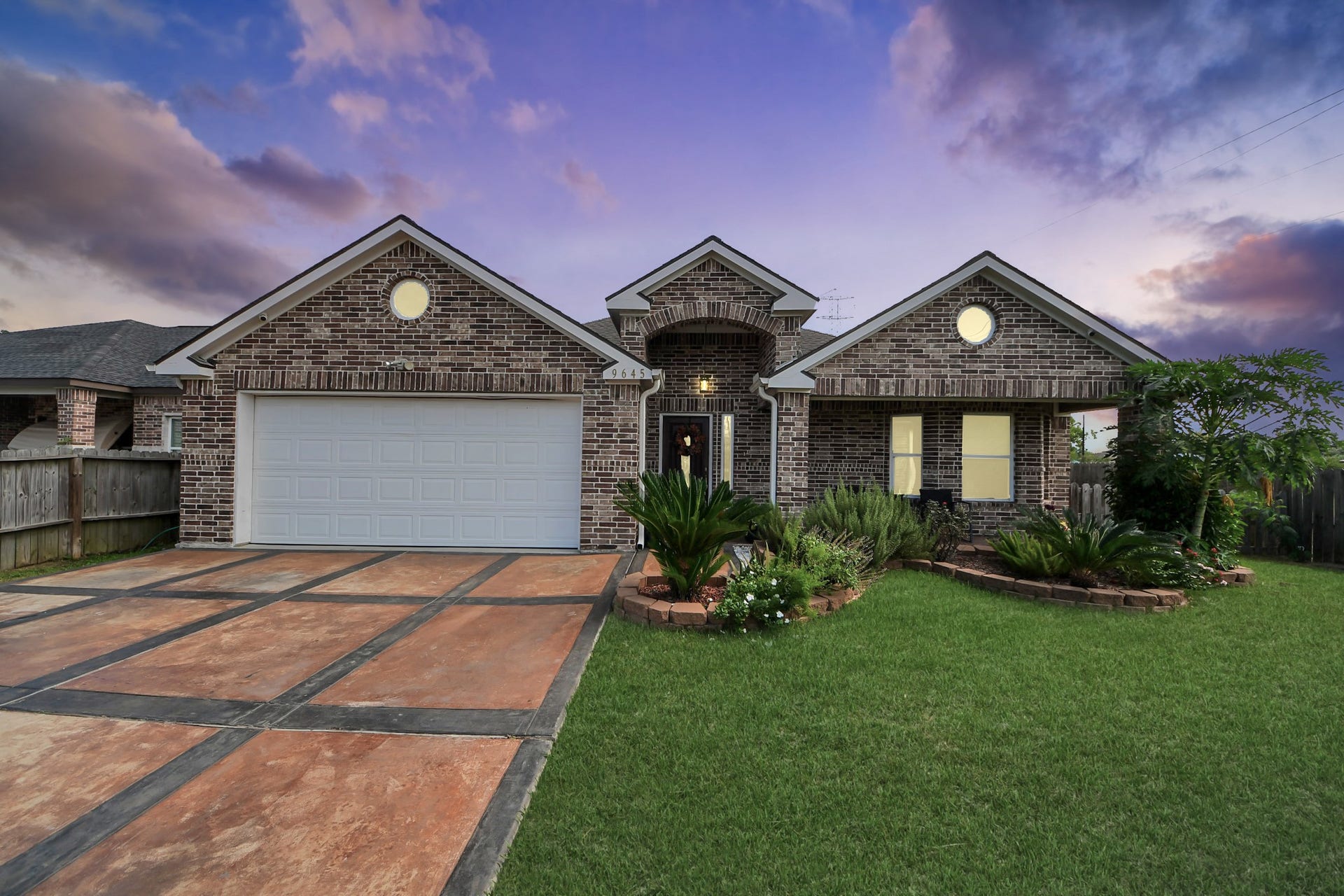 Twilight view highlights the front exterior and entry lighting.
