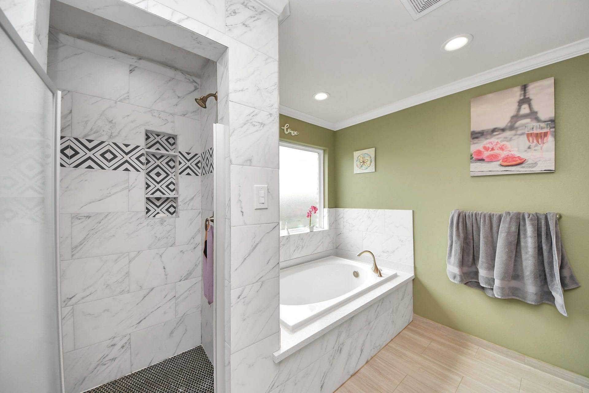 Separate tiled shower beside the primary bathroom tub.