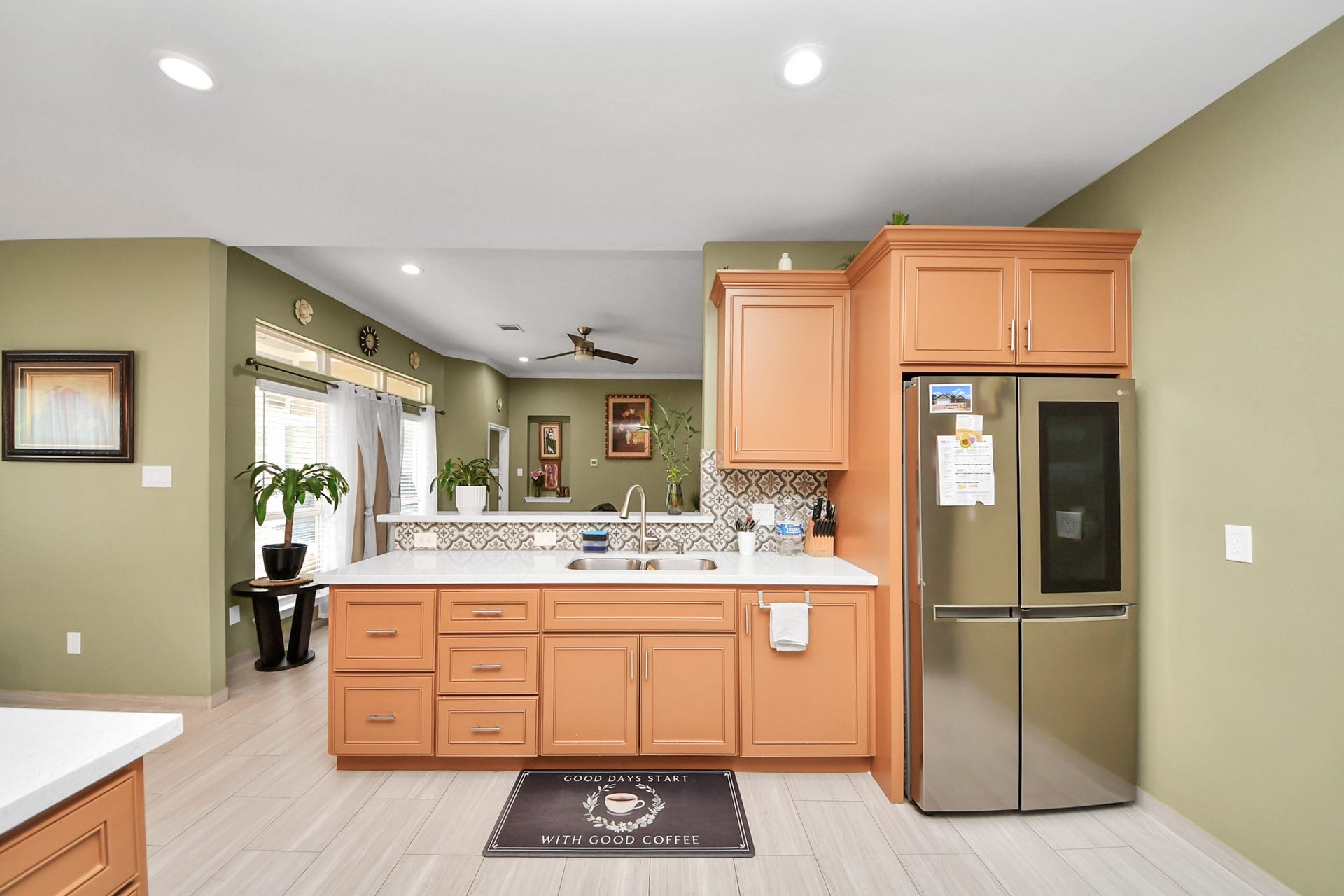 A raised breakfast bar connects the kitchen with nearby living areas.