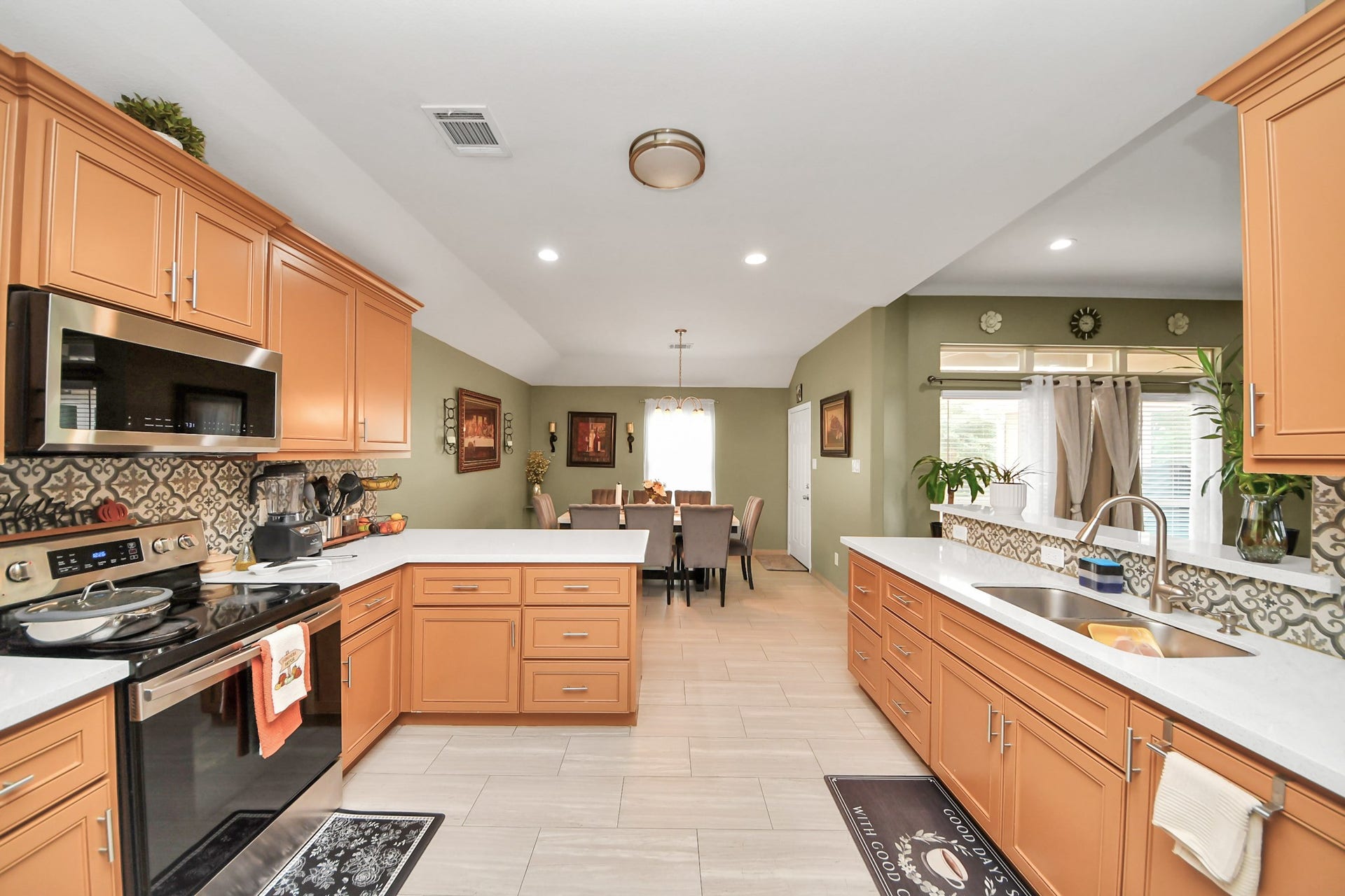 A wide kitchen view shows the counters, cabinetry, and adjoining dining area.