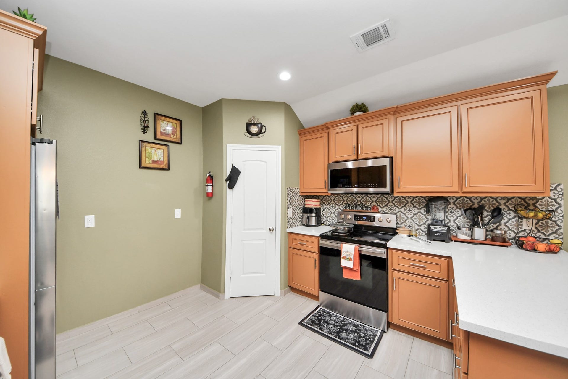 Another kitchen angle highlights cabinet storage and the cooking area.