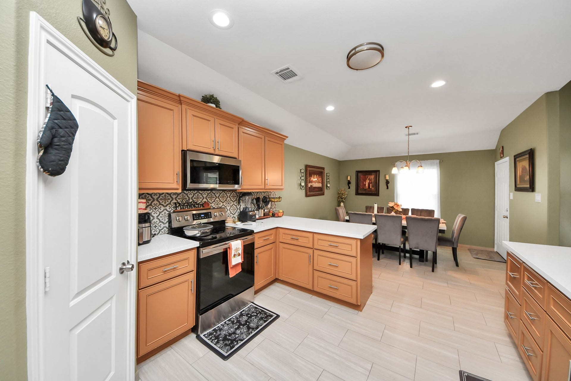 Tile flooring carries through the kitchen and into the dining area.