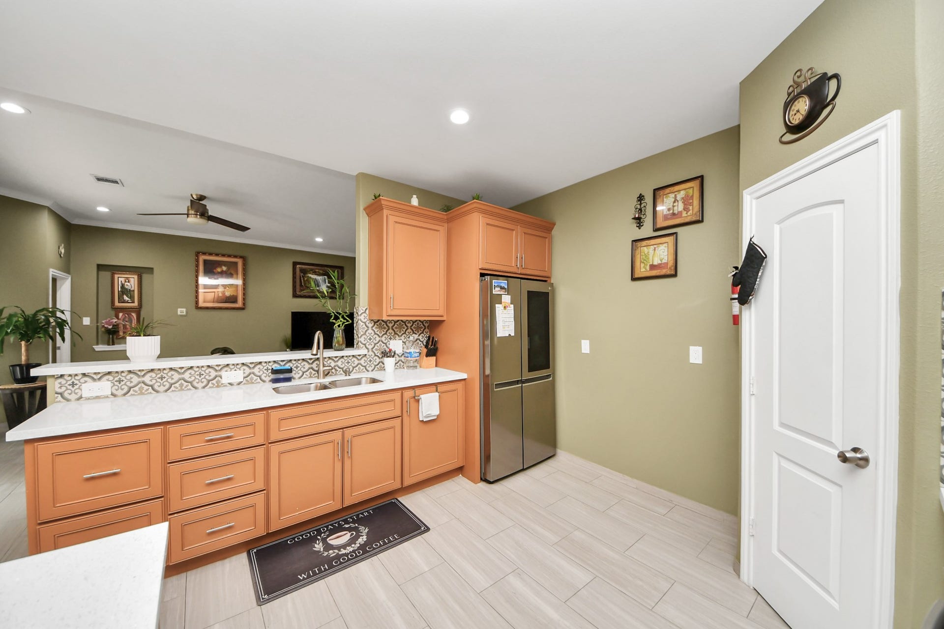 Kitchen sink and counter space with upper and lower cabinetry.