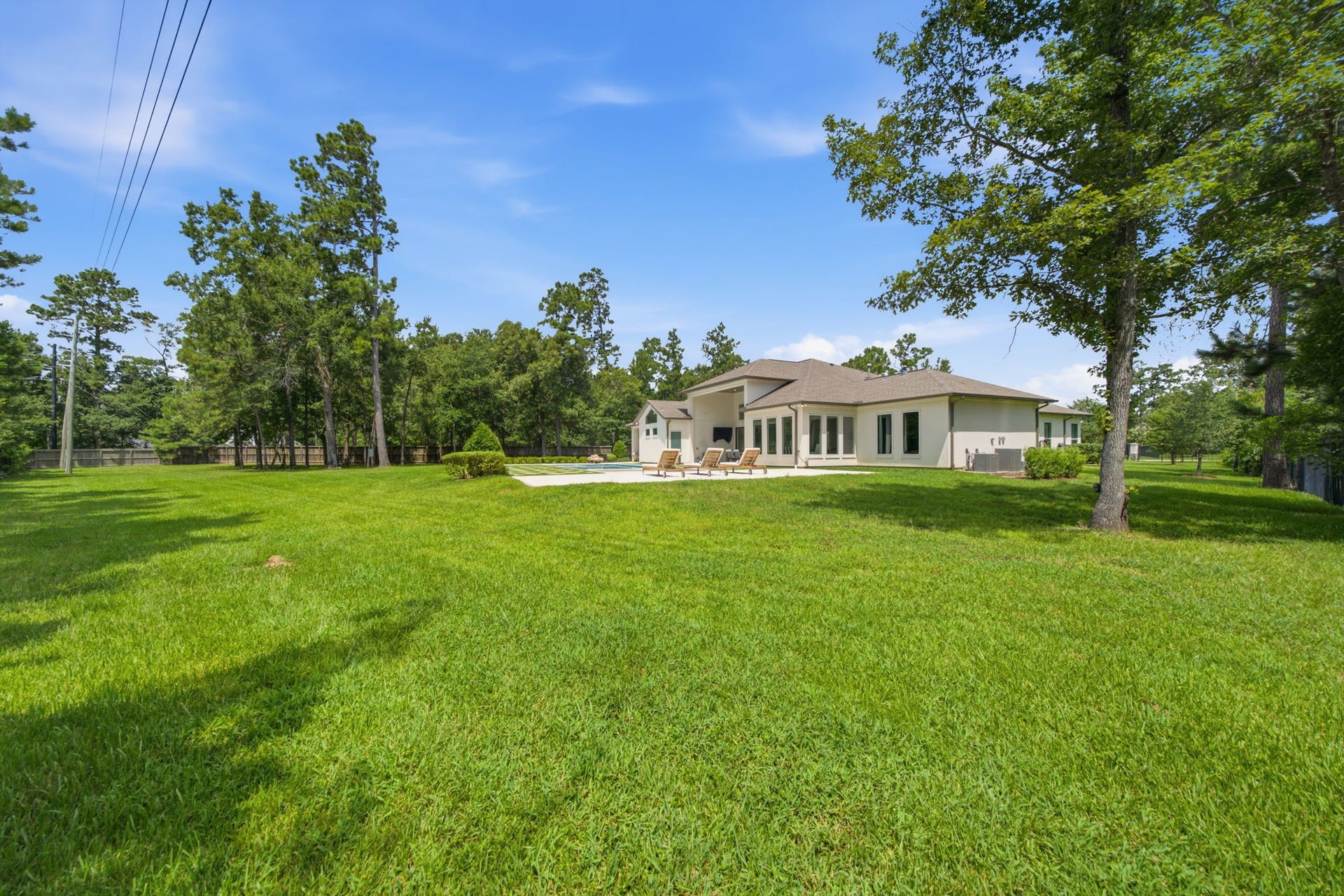 6310 Star Light Court, Spring, TX 77386 Expansive backyard with lush greenery and a spacious patio, perfect for outdoor relaxation and entertaining.