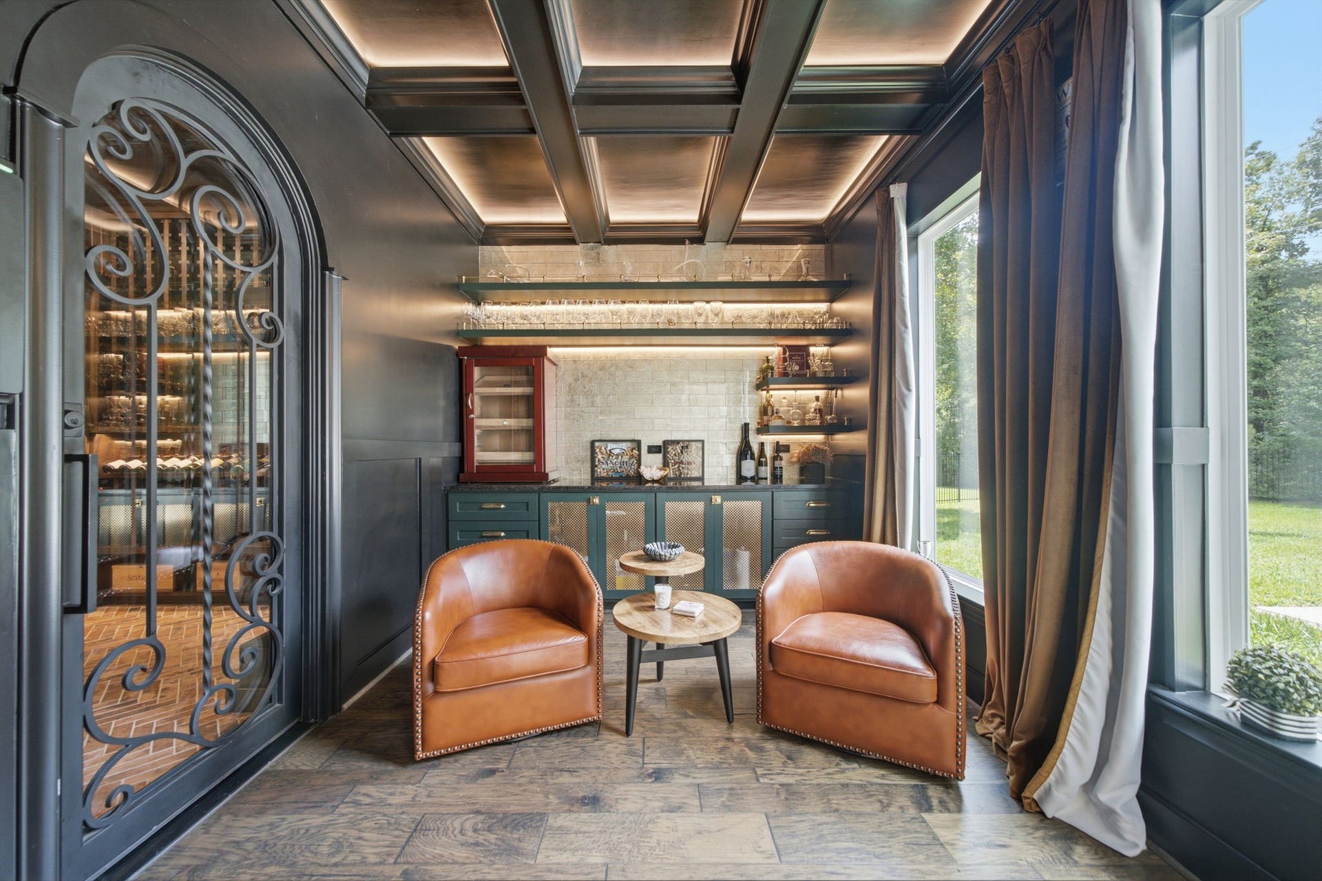 6310 Star Light Court, Spring, TX 77386 Elegant wine-tasting room featuring rich wood accents, leather seating, and a wall of glass overlooking serene greenery.