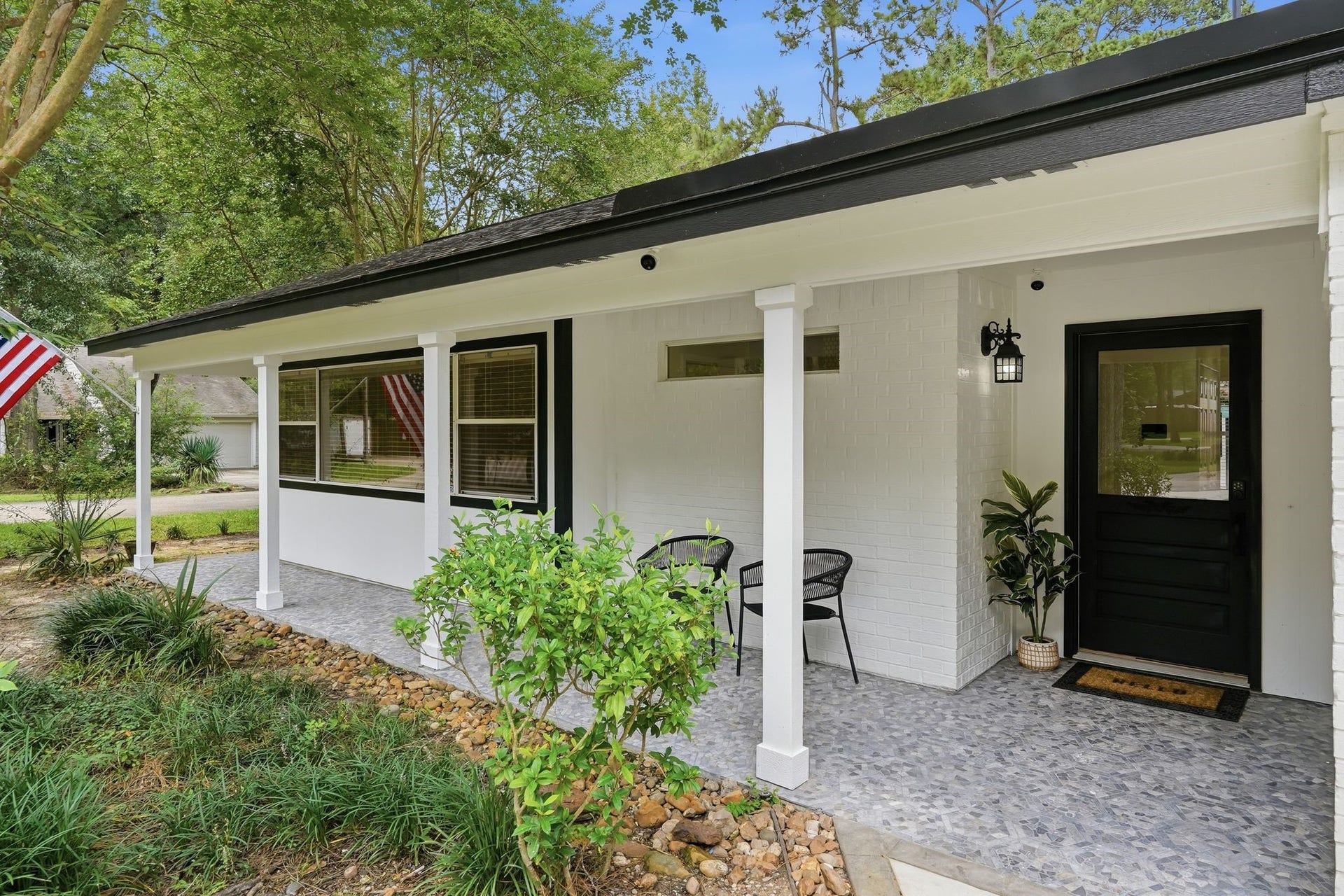 10916 Fawnlily Street, The Woodlands, TX 77380 This home has multiple entrances and front porches to give you many different areas to enjoy a cup of coffee and listen to the birds sing in the morning.