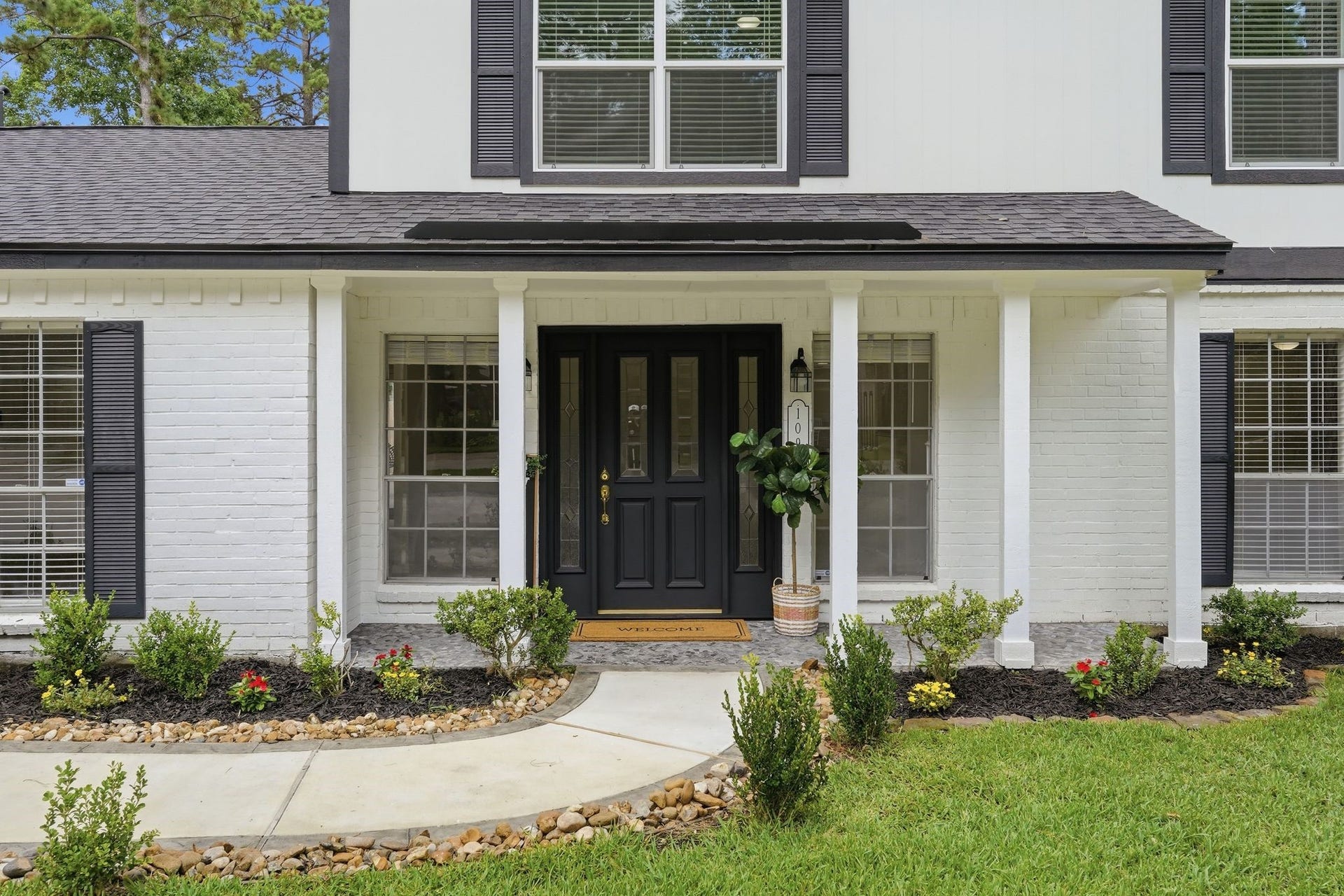 10916 Fawnlily Street, The Woodlands, TX 77380 Here is entrance number two, the main entrance to the home with another large front porch, perfect for decorating for every season.
