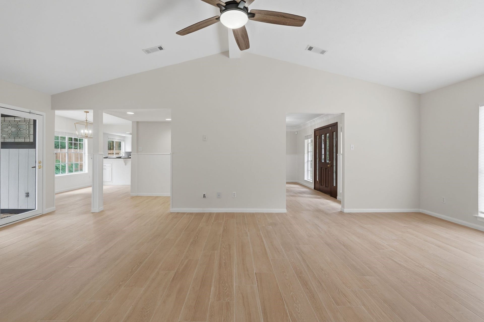 10916 Fawnlily Street, The Woodlands, TX 77380 This shows just how big this space is. Notice your front door in the background to the right, your breakfast nook to the left and a door to your backyard in the far left. There is a cool little alcove between your living room and your breakfast nook. Make it a little office space, a dry bar, another seating area, or anything else you can dream up!