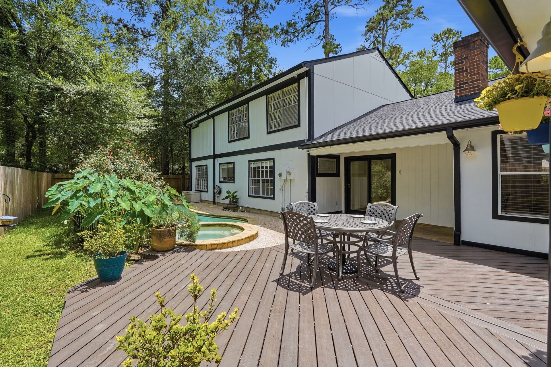 10916 Fawnlily Street, The Woodlands, TX 77380 Now, the moment you've been waiting for, THE BACKYARD! This extended patio and pool makes this space a whole vibe.