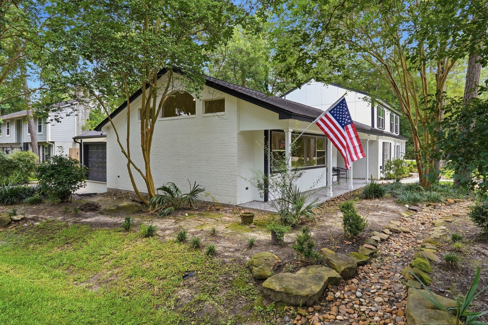 10916 Fawnlily Street, The Woodlands, TX 77380 Tucked on the left side of your home is a large front porch and a peek at your garage with additional parking!