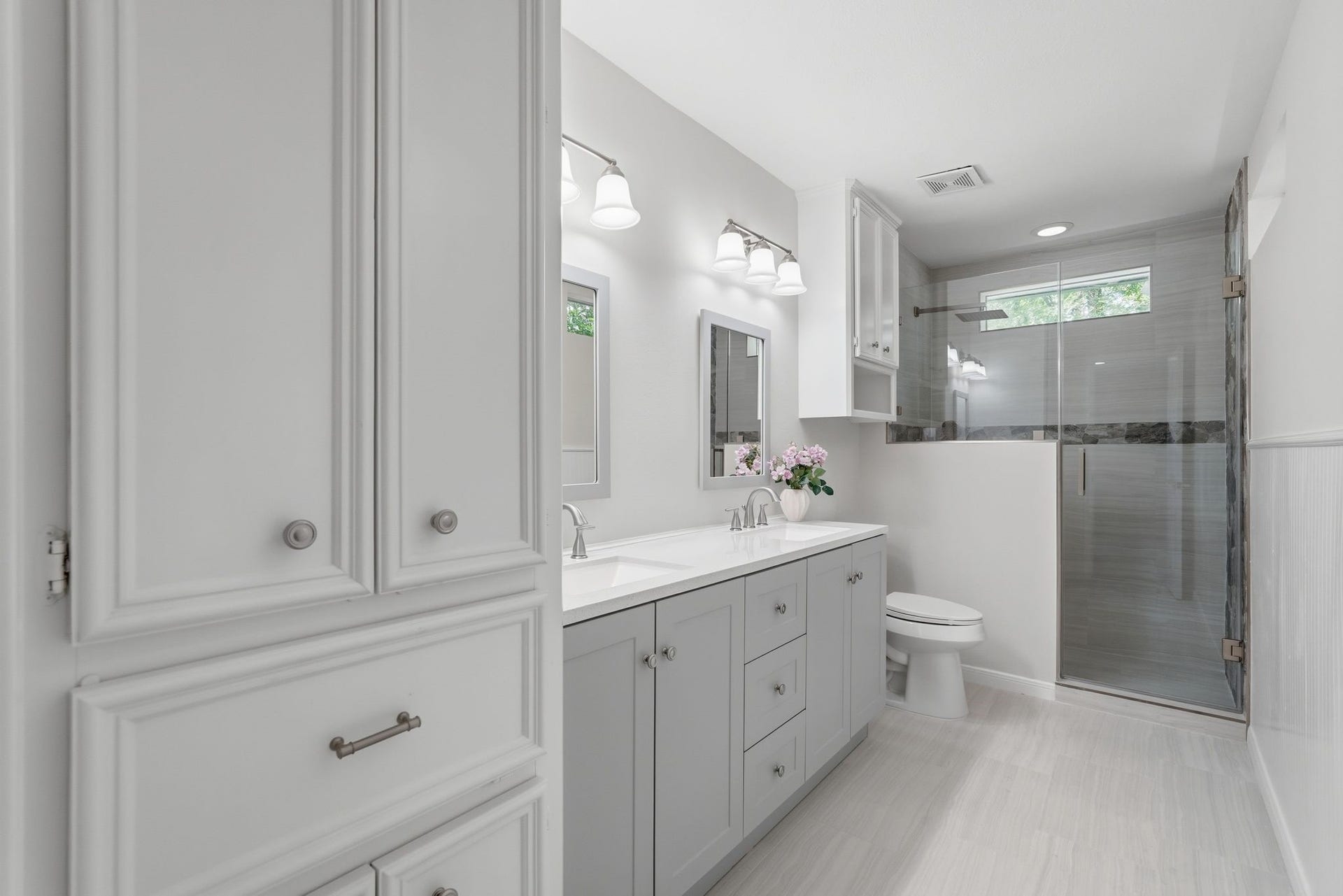 10916 Fawnlily Street, The Woodlands, TX 77380 This second primary bathroom has a large double sink countertops, storage just inside the door and a spacious walk in shower.