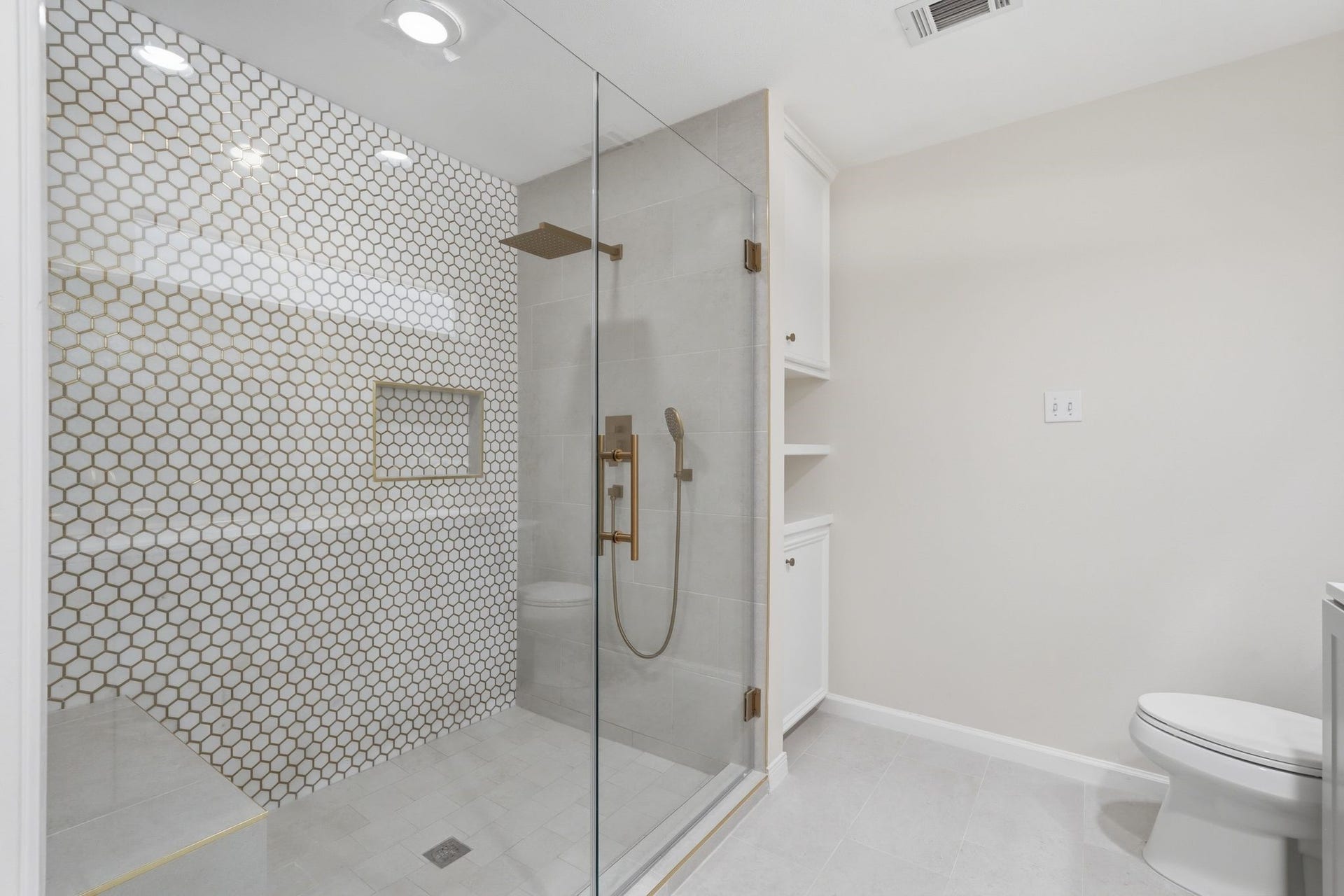10916 Fawnlily Street, The Woodlands, TX 77380 This shower is HUGE!! It has a rain shower head, a convenient place to store your toiletries and a bench seat!