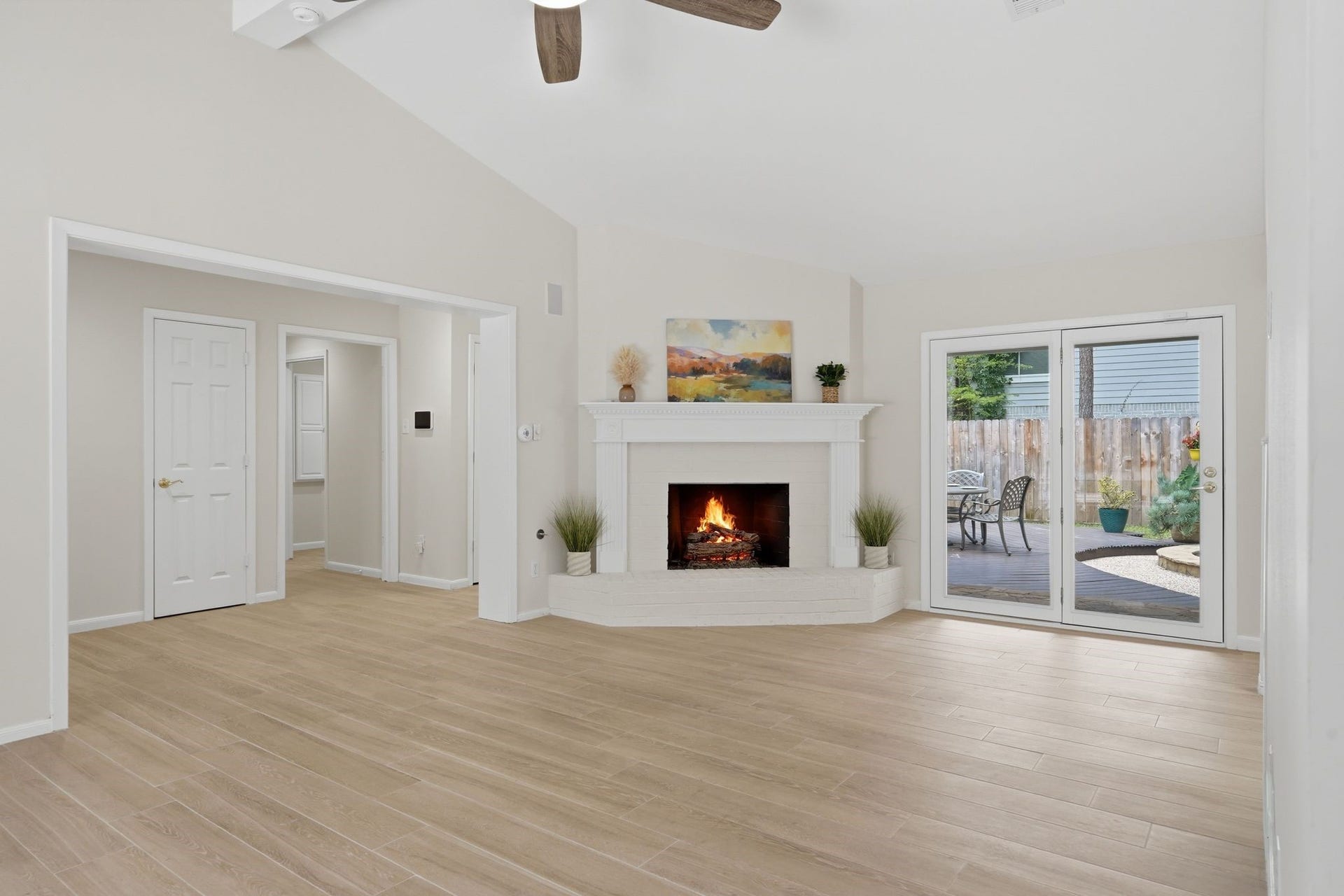 10916 Fawnlily Street, The Woodlands, TX 77380 From this view you can see through the door on the left the hallway to your primary bedroom, laundry room, and another entrance to your backyard.