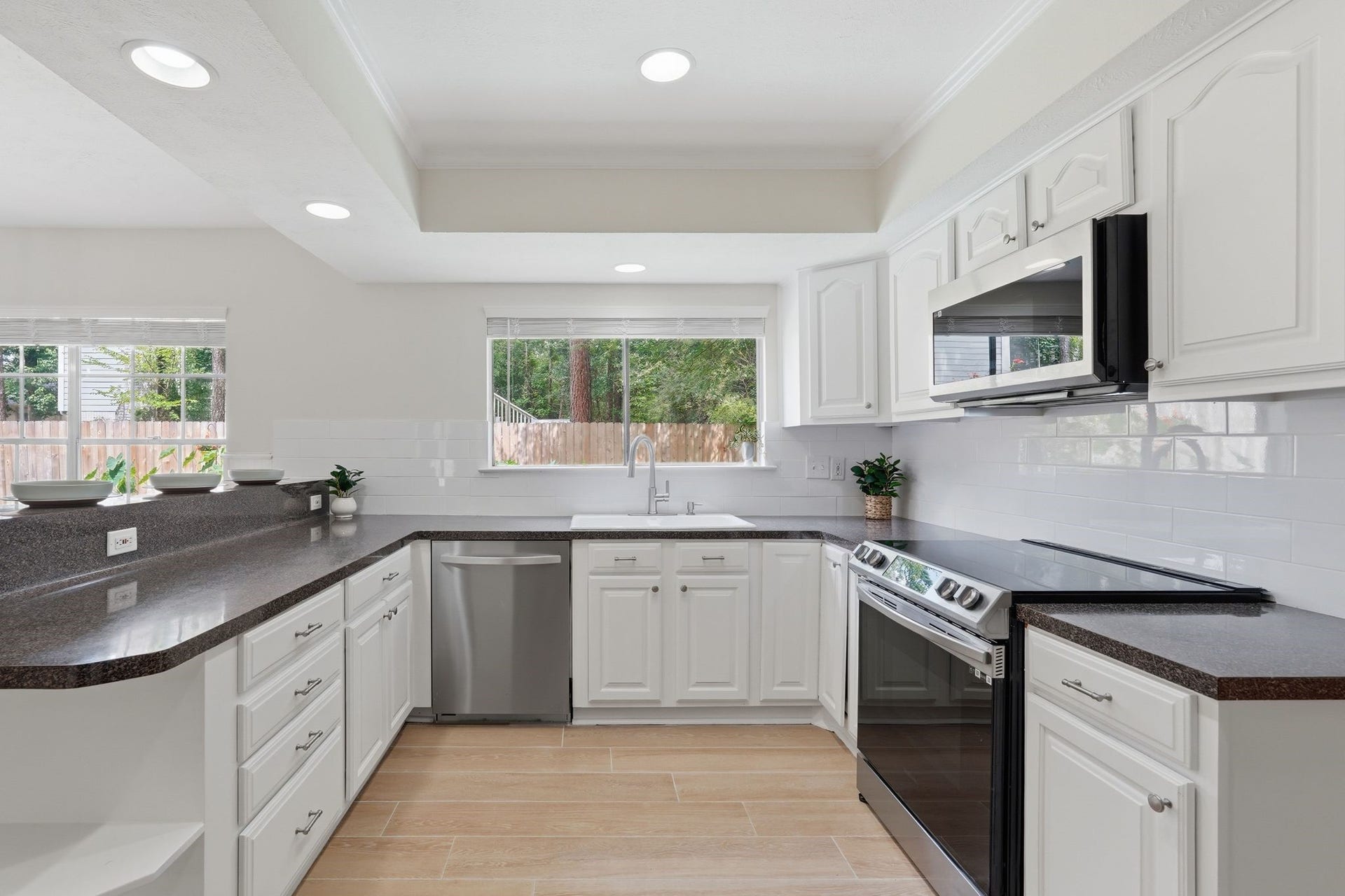 10916 Fawnlily Street, The Woodlands, TX 77380 Notice the fresh paint and backsplash in the kitchen and all the natural light in this space.