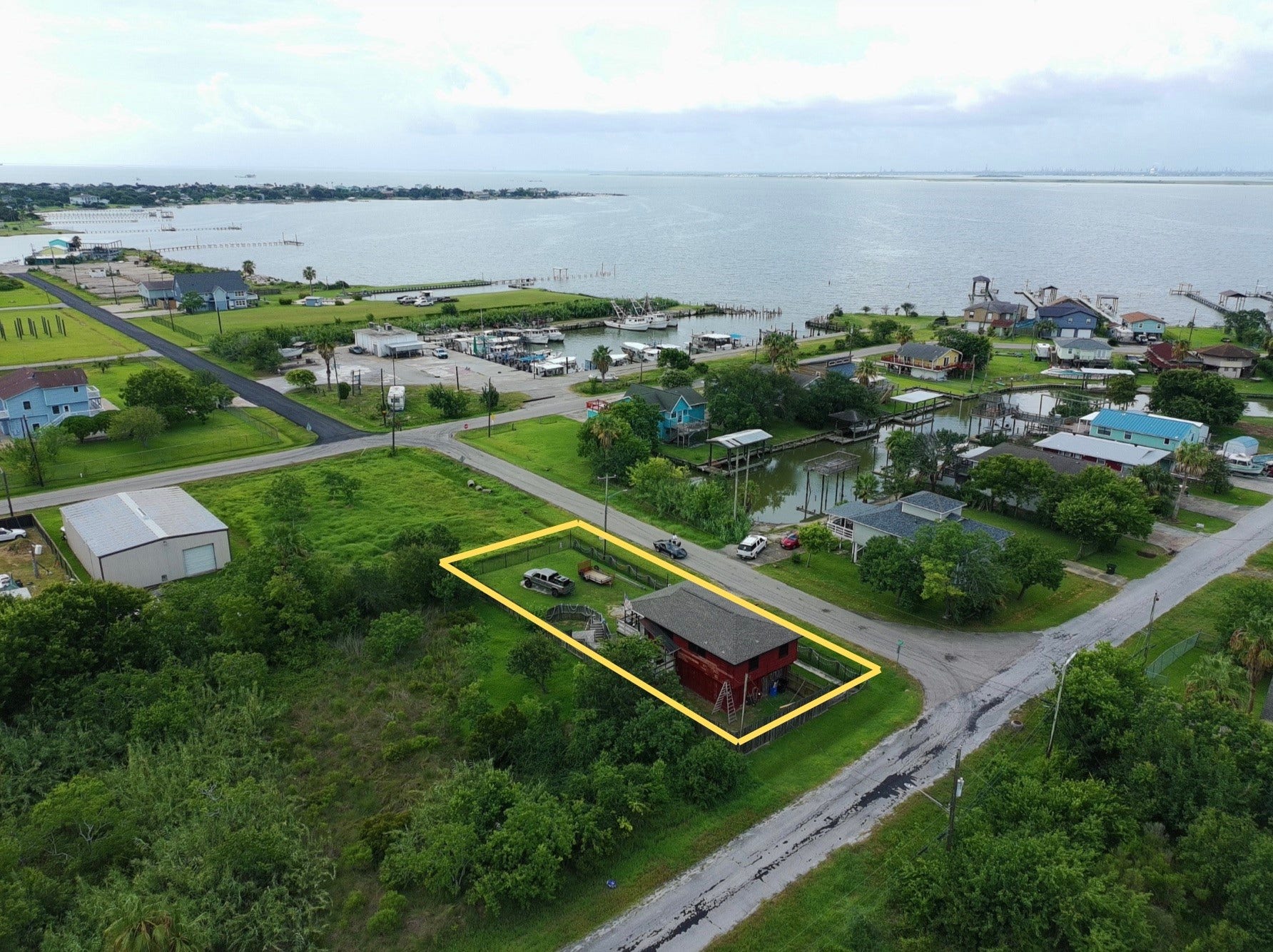 1019 Sunset Drive, San Leon, TX 77539 overhead view shows proximity to water (red house) (yellow boundary lines are approximate, refer to provided survey)