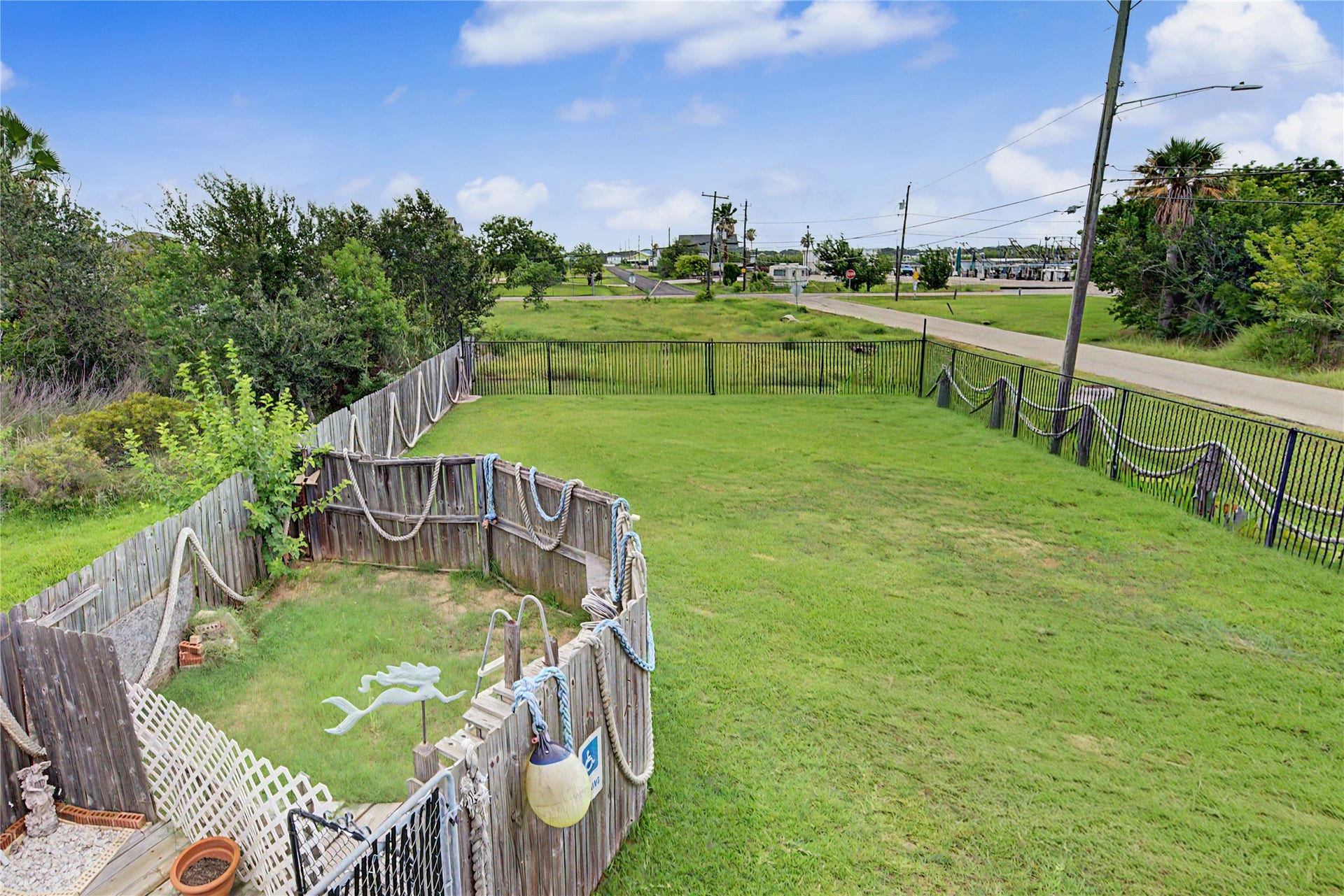 1019 Sunset Drive, San Leon, TX 77539 View of property from porch (the fenced area had a small above ground pool)