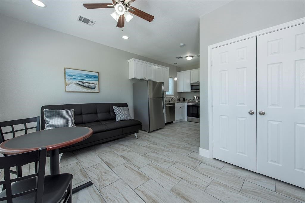 203 6th St, #D, San Leon, TX 77539 Tile flooring throughout in all units. Living area opens to kitchen.