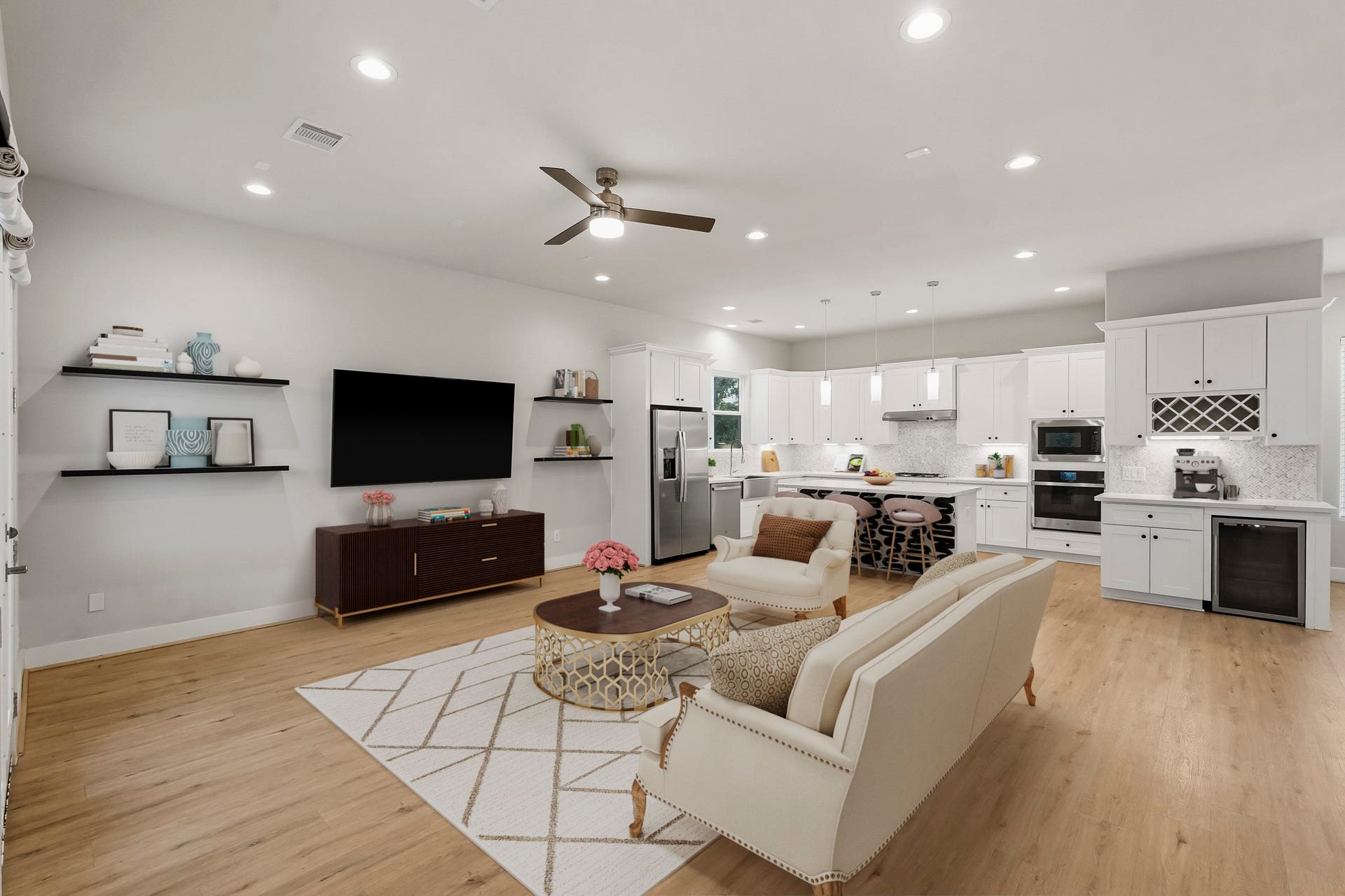 3109 Arlington Street, Houston, TX 77018 Virtually Staged: Spacious and bright living room featuring an open-concept layout, luxury vinyl plank flooring, recessed lighting, and a modern ceiling fan. The expansive space offers plenty of room for multiple seating arrangements, while a wall-mounted TV with floating shelves creates a natural entertainment area.