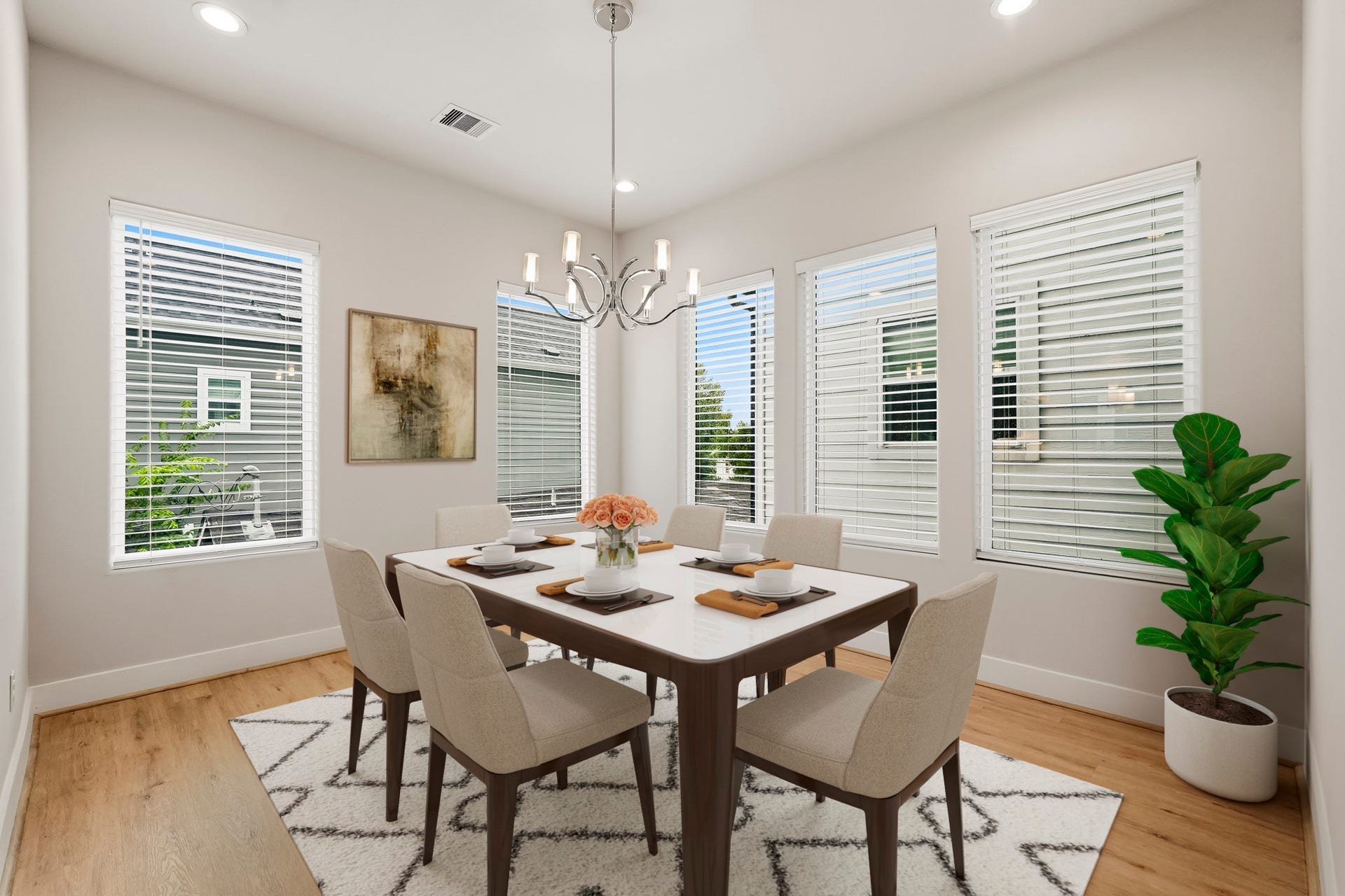 3109 Arlington Street, Houston, TX 77018 Virtually Staged: Bright and elegant dining area featuring multiple large windows which will fill the room with abundant natural light. It includes luxury vinyl plank flooring, recessed lighting, and a contemporary chandelier create a polished and inviting setting for everyday dining and entertaining.