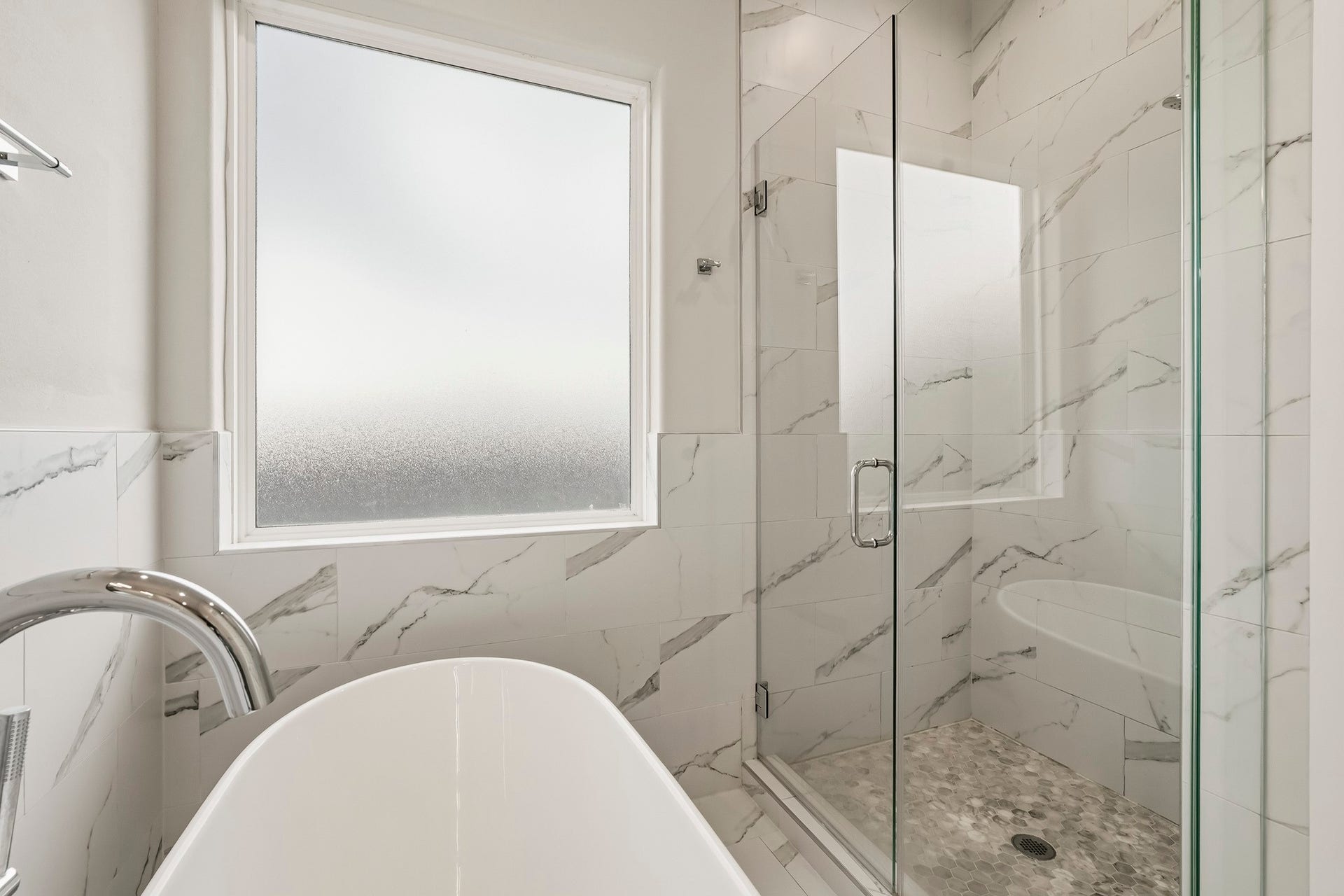 3109 Arlington Street, Houston, TX 77018 A large frosted window fills the space with natural light while maintaining privacy, creating a bright, luxurious retreat.