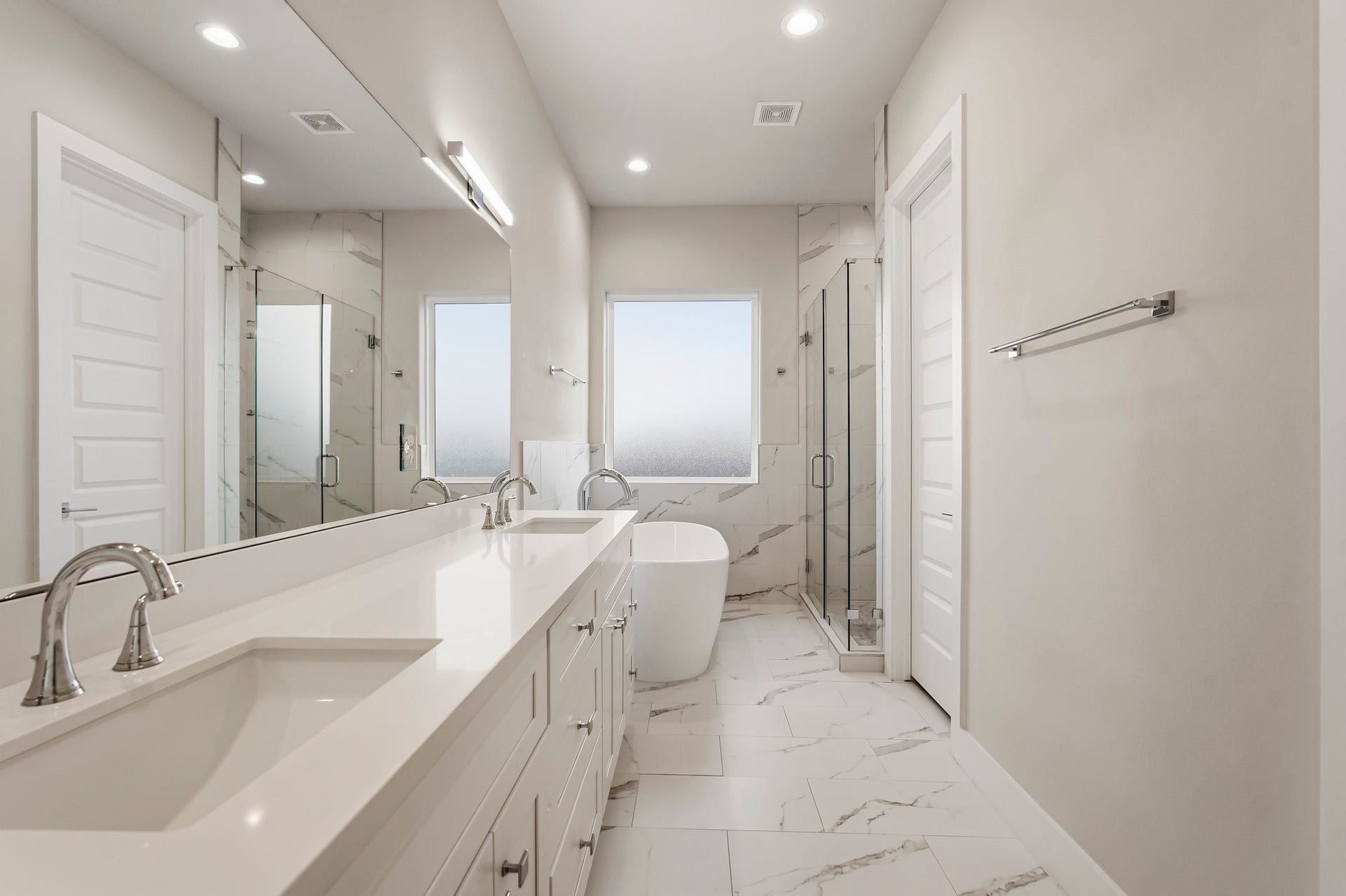 3109 Arlington Street, Houston, TX 77018 Luxurious primary bathroom featuring a long dual-sink vanity with abundant cabinetry, sleek countertops, and an expansive wall mirror.