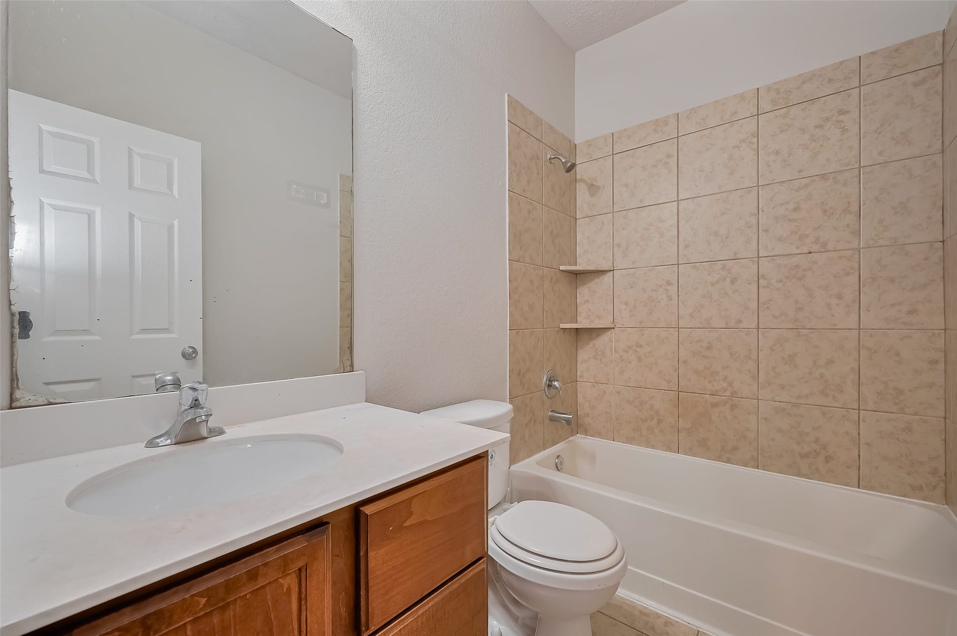 24114 Morrison Lane, Katy, TX 77493 Versatile bathroom featuring a shower-tub combo & wooden vanity.
