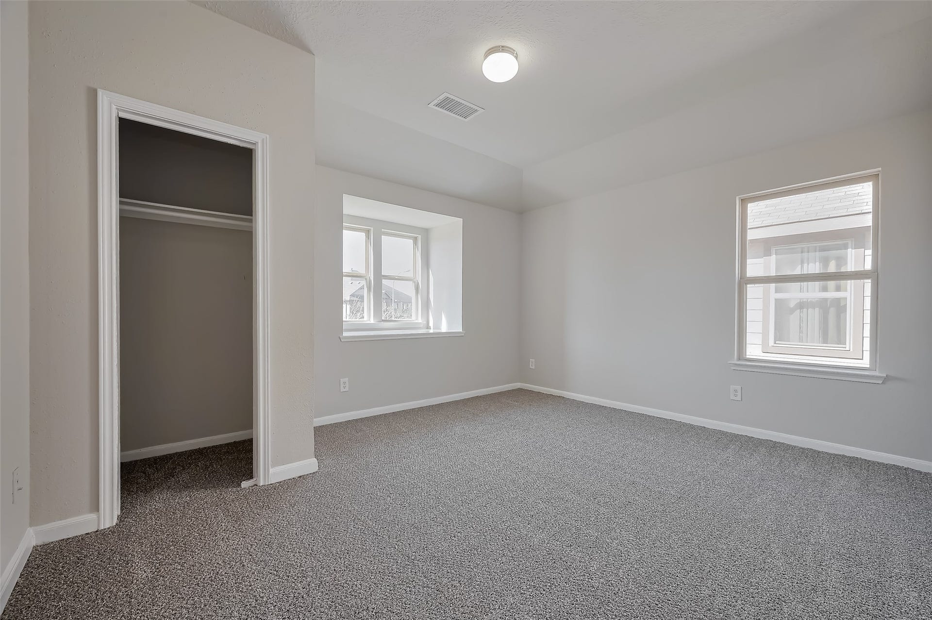 24114 Morrison Lane, Katy, TX 77493 Bedroom with small closet, carpet, and two windows.