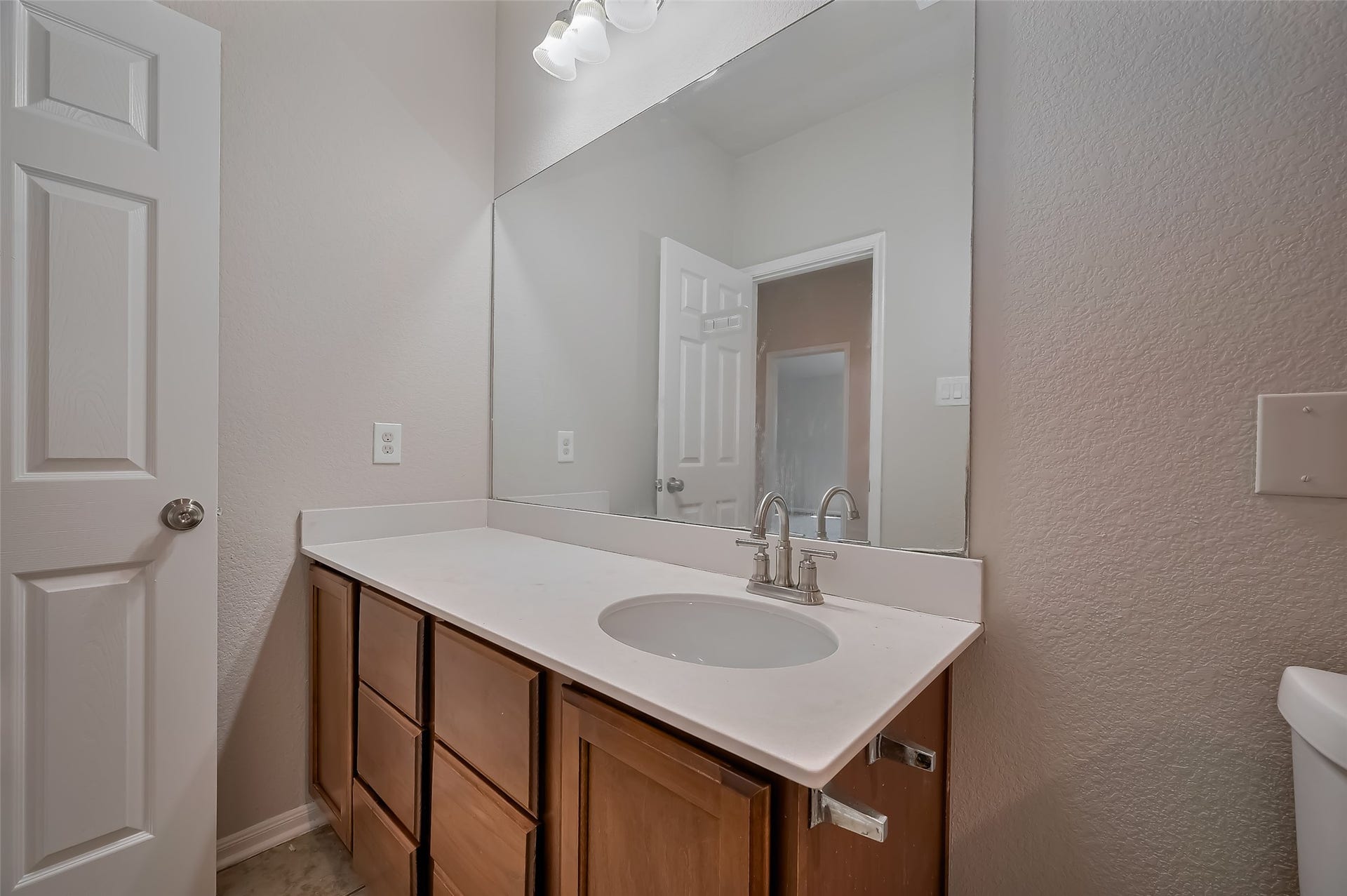 24114 Morrison Lane, Katy, TX 77493 Modern bathroom with a large mirror & single sink vanity.