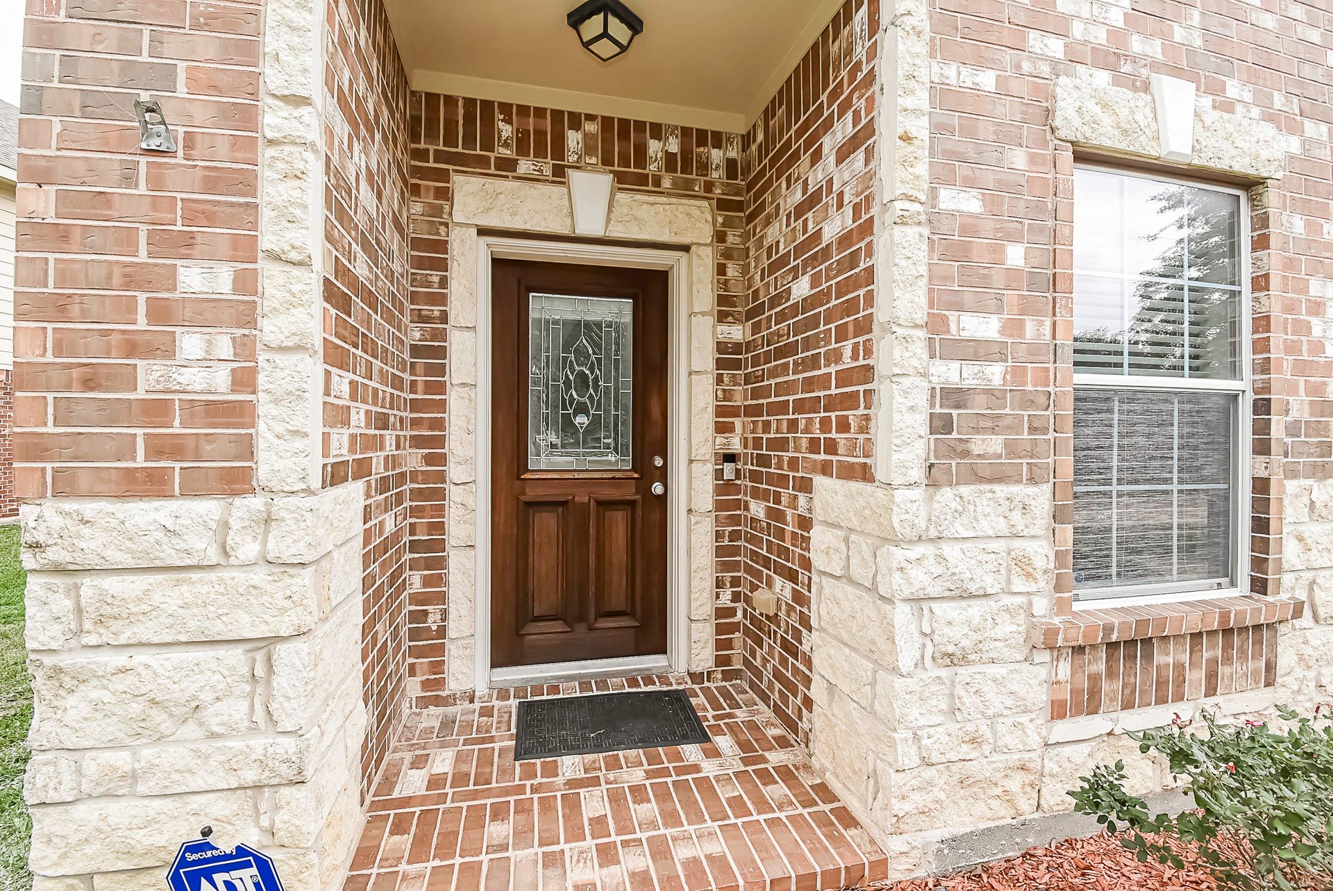 3615 Morning Gale Lane, Katy, TX 77494 A brick-lined entryway leads you to the welcoming mahogany front door.