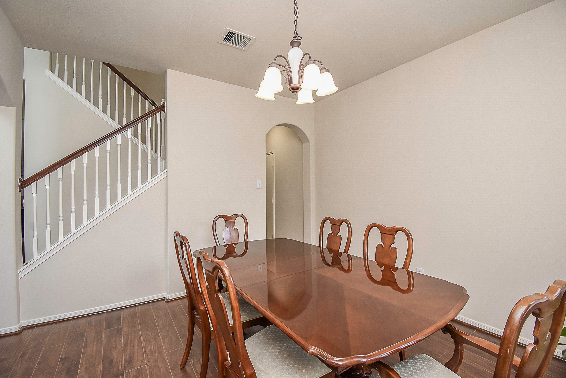 3615 Morning Gale Lane, Katy, TX 77494 Step through the arched entryways that seamlessly connect the formal dining room to the spacious living area.