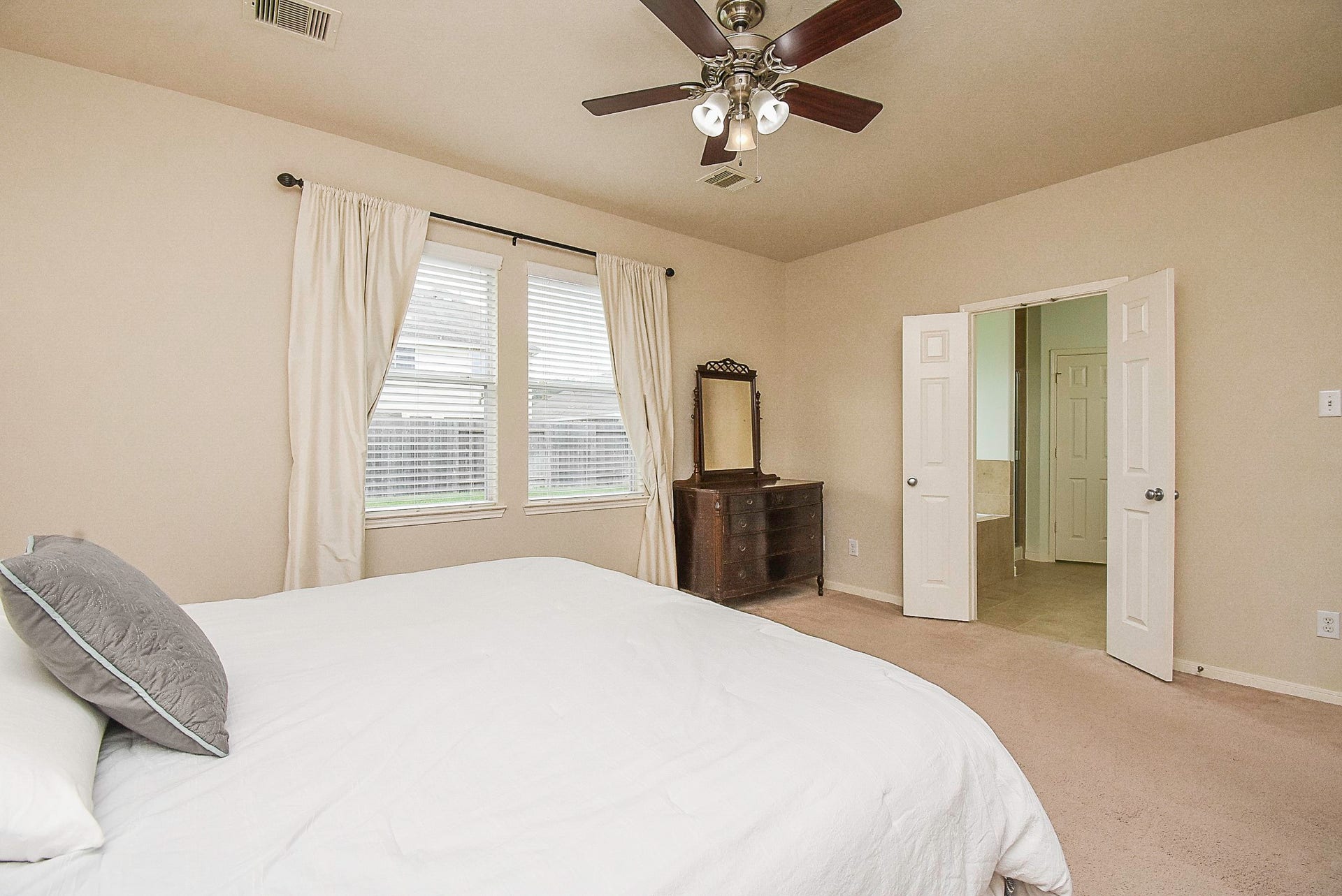 3615 Morning Gale Lane, Katy, TX 77494 Another view of the spacious primary bedroom, featuring large windows, and direct access to the en-suite bathroom.