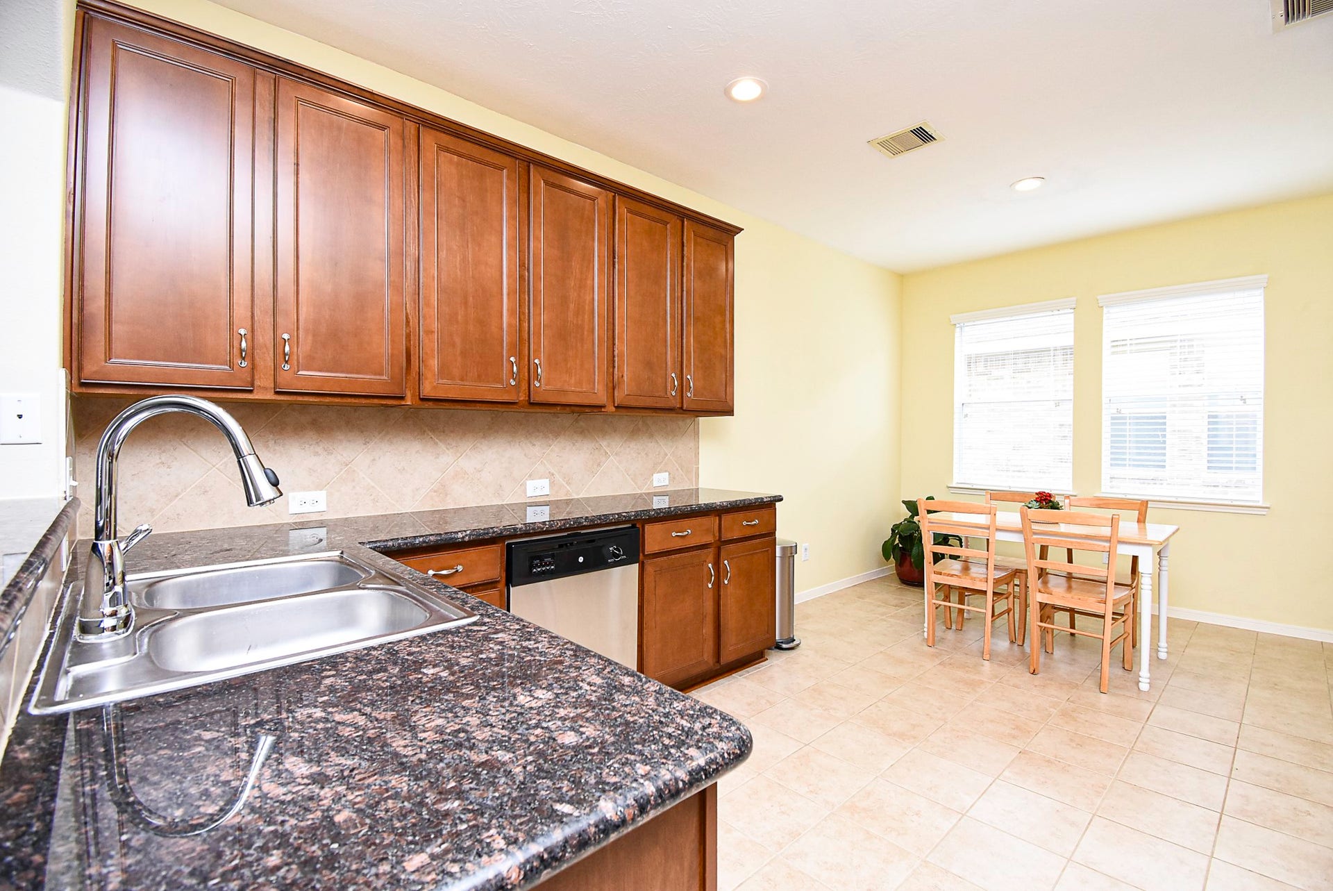 3615 Morning Gale Lane, Katy, TX 77494 Wood cabinetry and granite countertops complement this spacious, open kitchen.