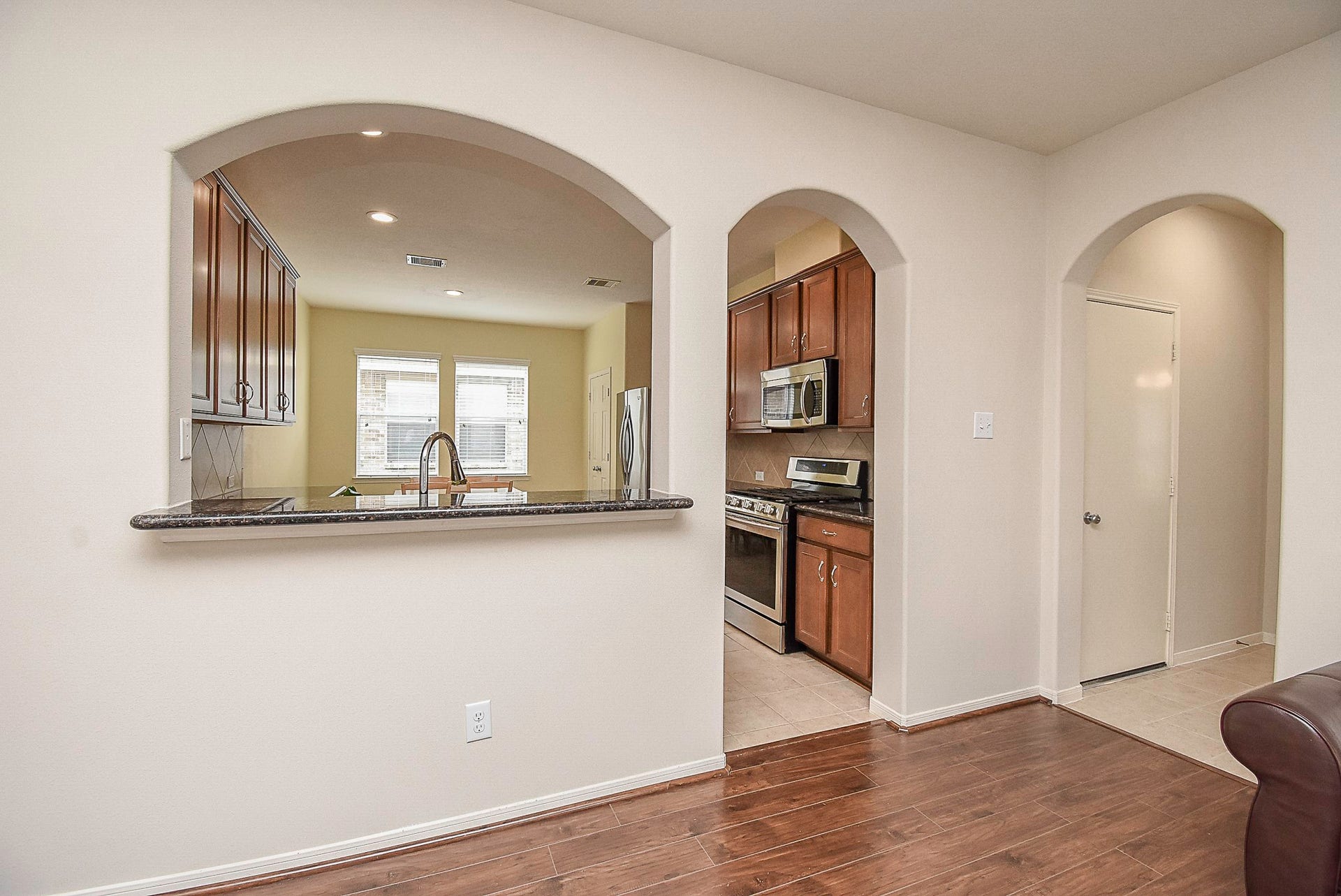 3615 Morning Gale Lane, Katy, TX 77494 Breakfast bar with a well-placed passthrough window peering into the kitchen.