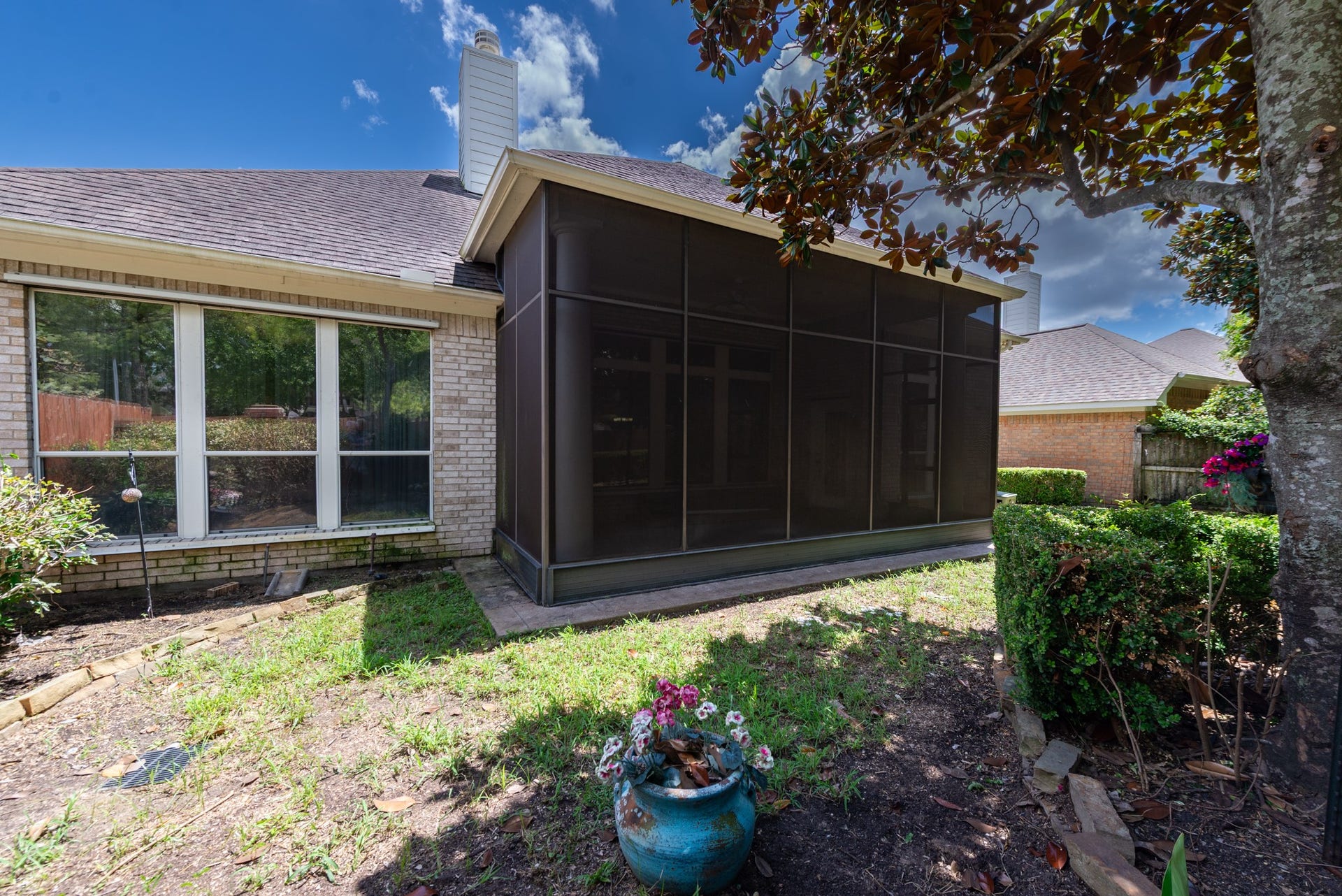 24922 Cinco Manor Lane, Katy, TX 77494 Another view of the screened patio and backyard, showcasing the home's outdoor living space and mature surroundings.