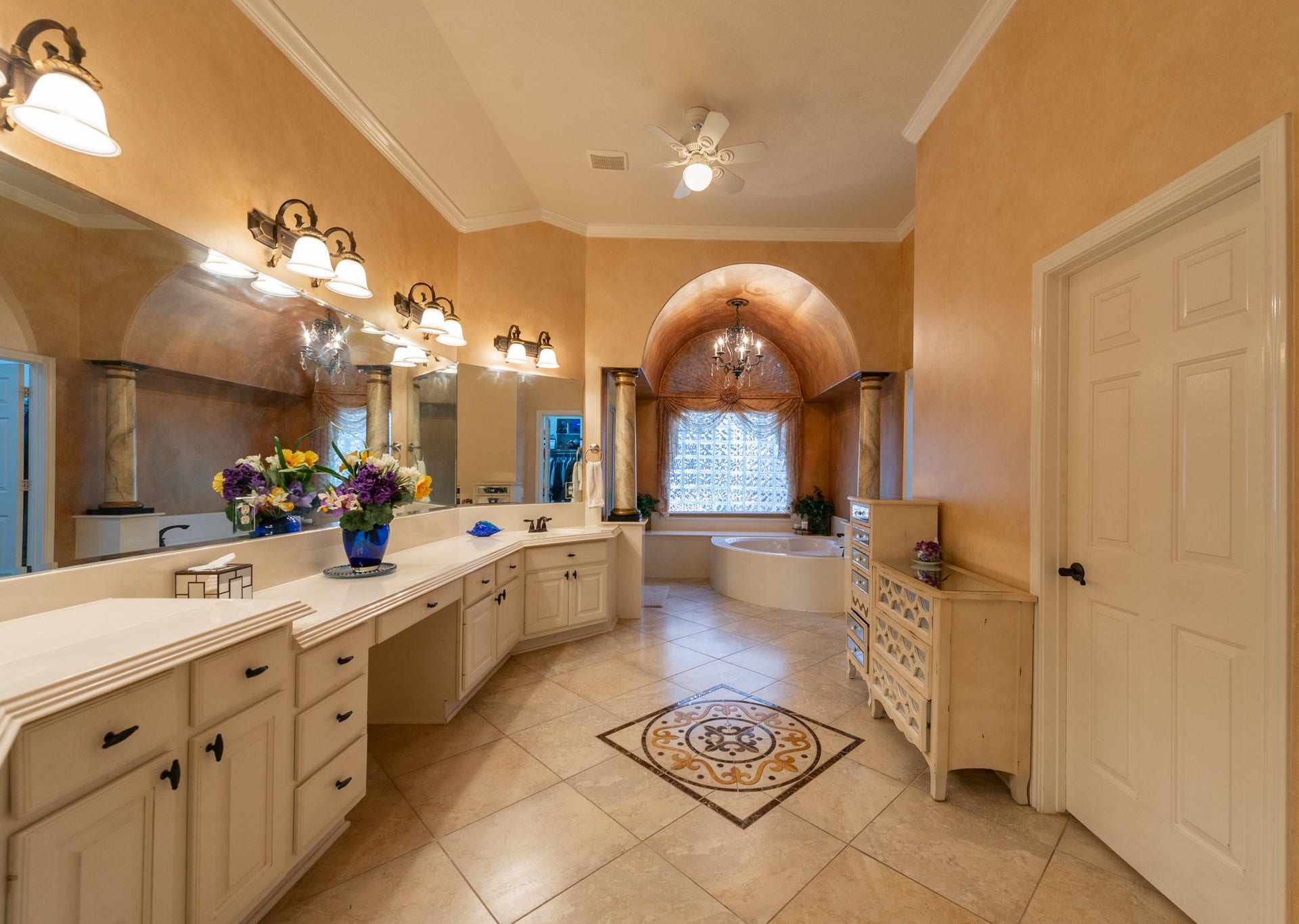 24922 Cinco Manor Lane, Katy, TX 77494 Spacious primary bath with an extended vanity, decorative tile flooring, high ceiling and separate bathing areas.