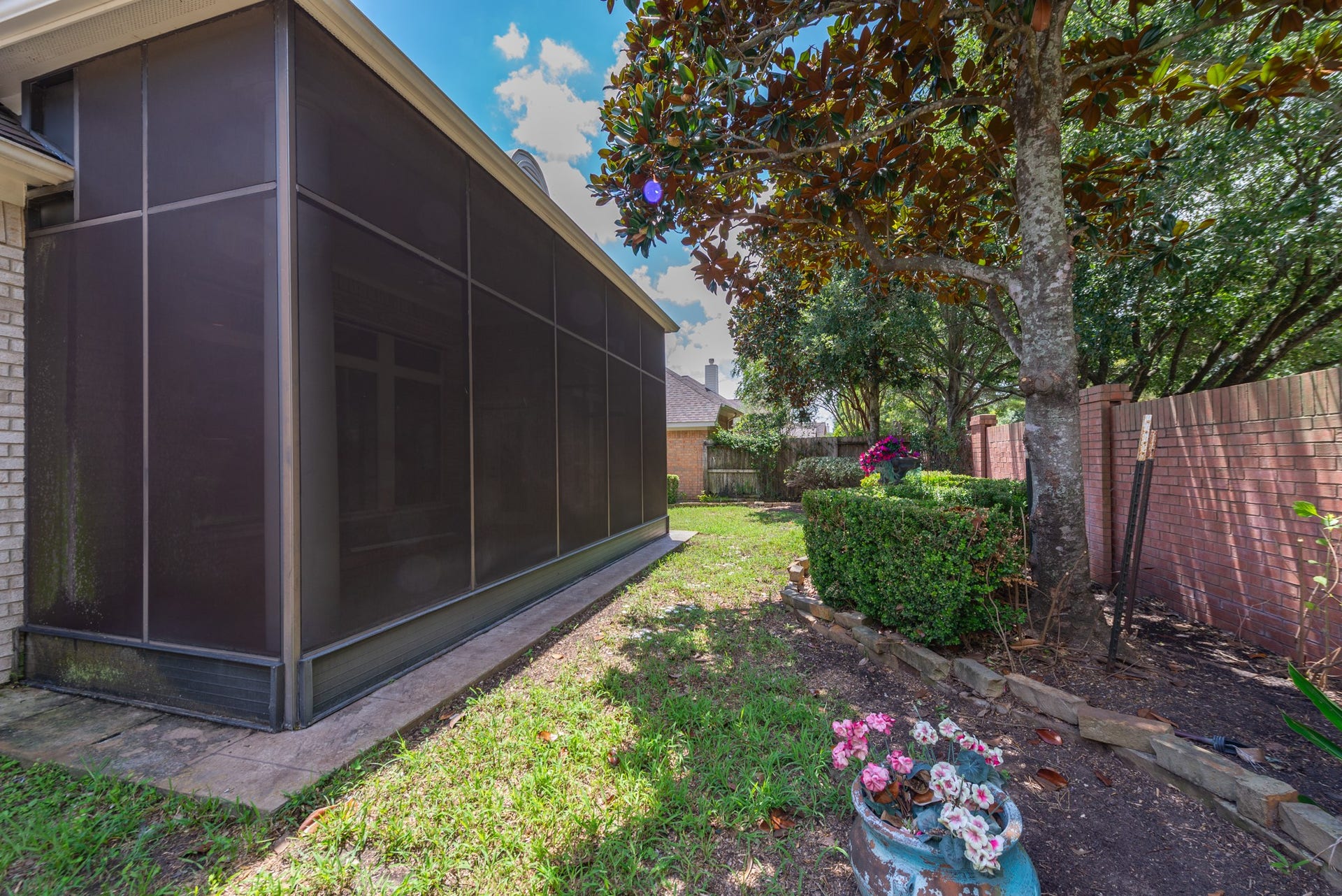 24922 Cinco Manor Lane, Katy, TX 77494 Mature trees and established landscaping create a shaded, private setting beside the screened patio.