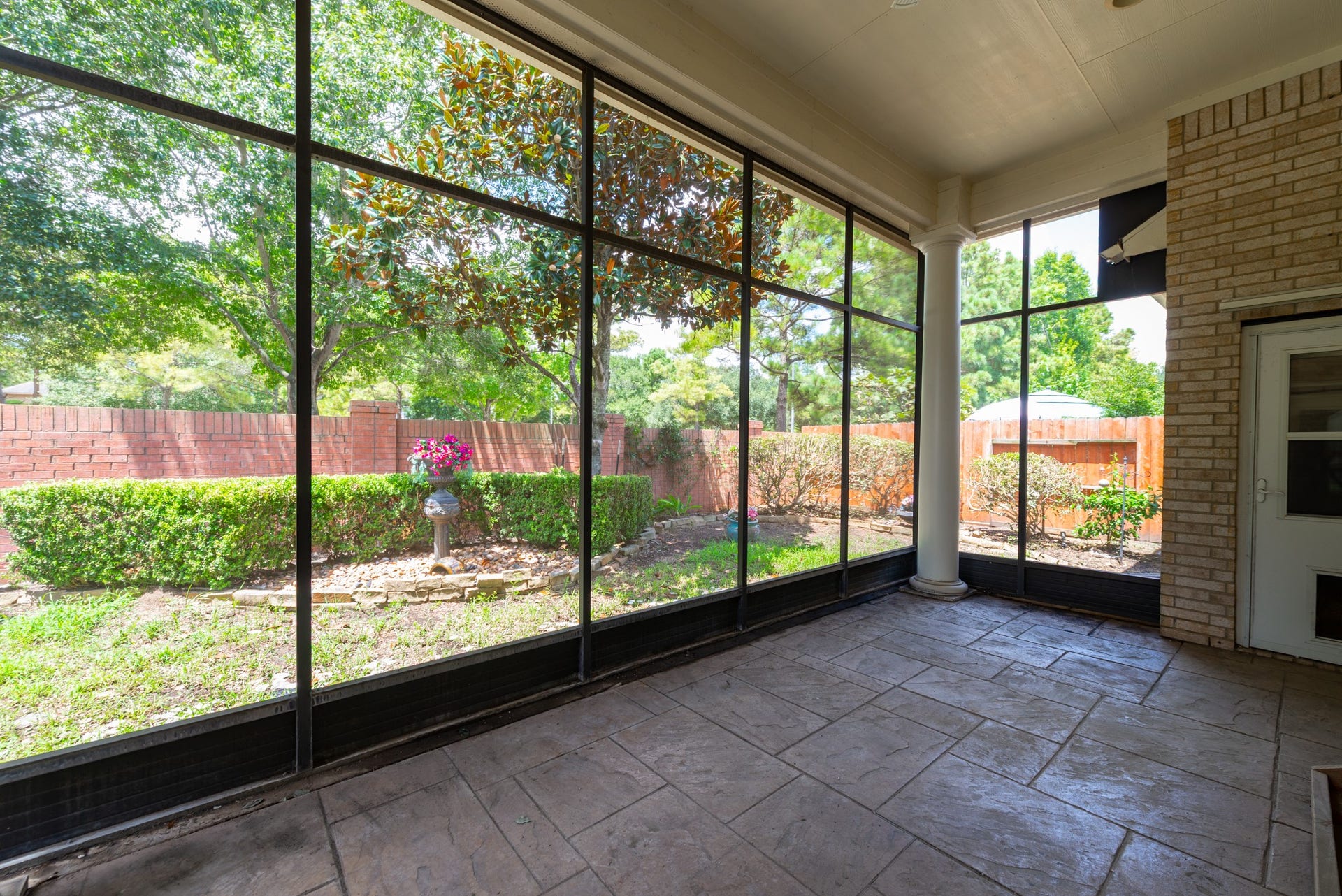 24922 Cinco Manor Lane, Katy, TX 77494 Spacious screened-in patio with stamped concrete flooring and peaceful views of the backyard.