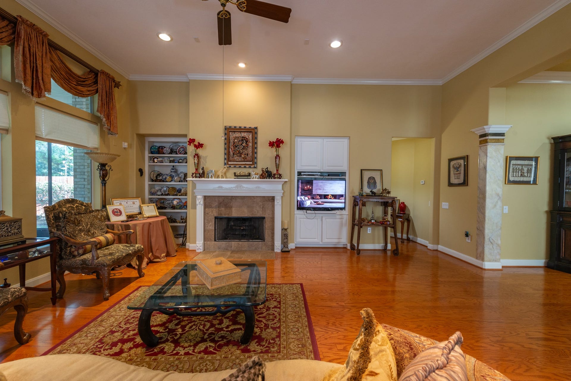 24922 Cinco Manor Lane, Katy, TX 77494 A wide view of the living room highlights the high ceiling, fireplace, built-ins and generous floor space.