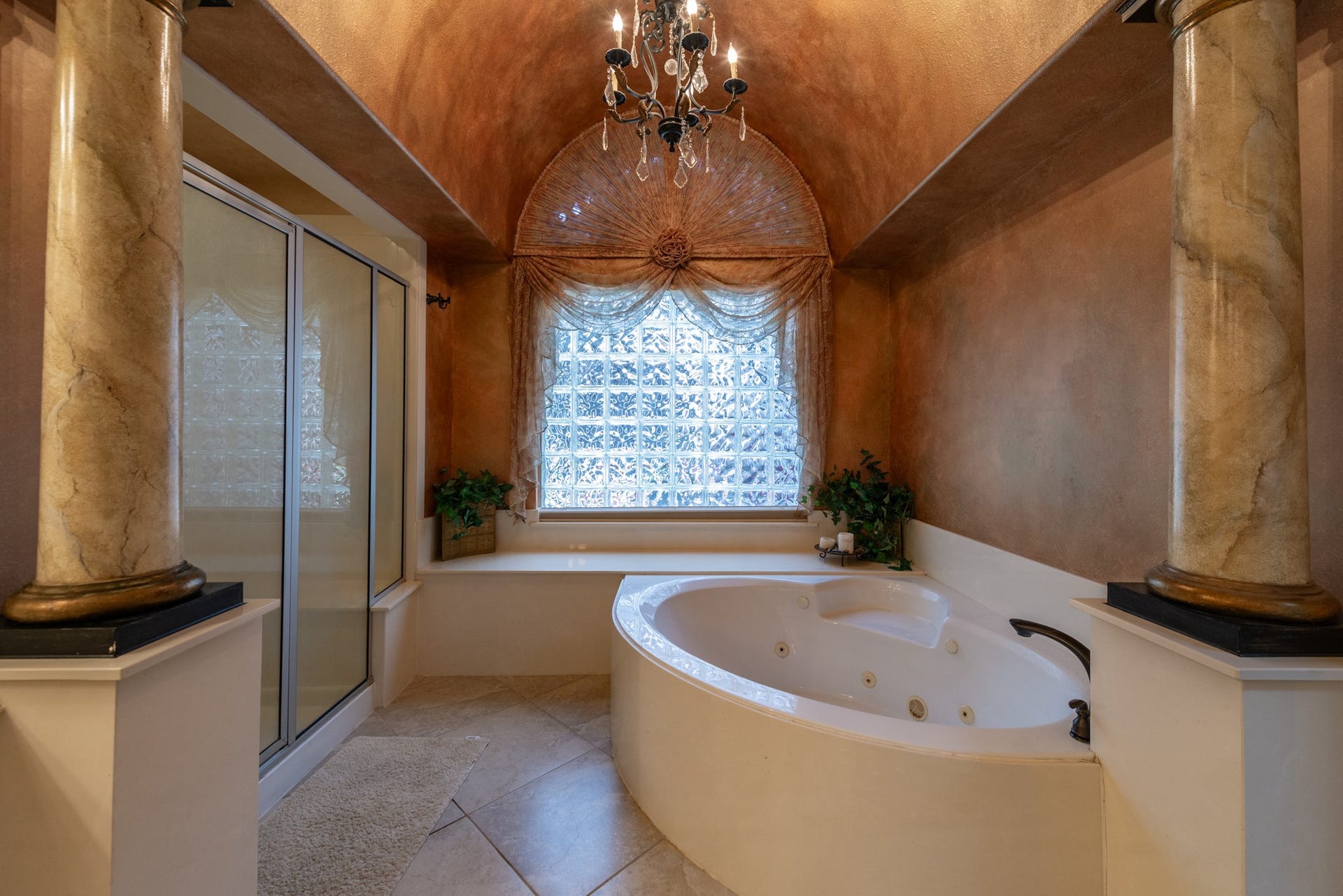 24922 Cinco Manor Lane, Katy, TX 77494 Architectural columns frame the jetted tub and separate shower, creating a distinctive retreat within the primary bath.